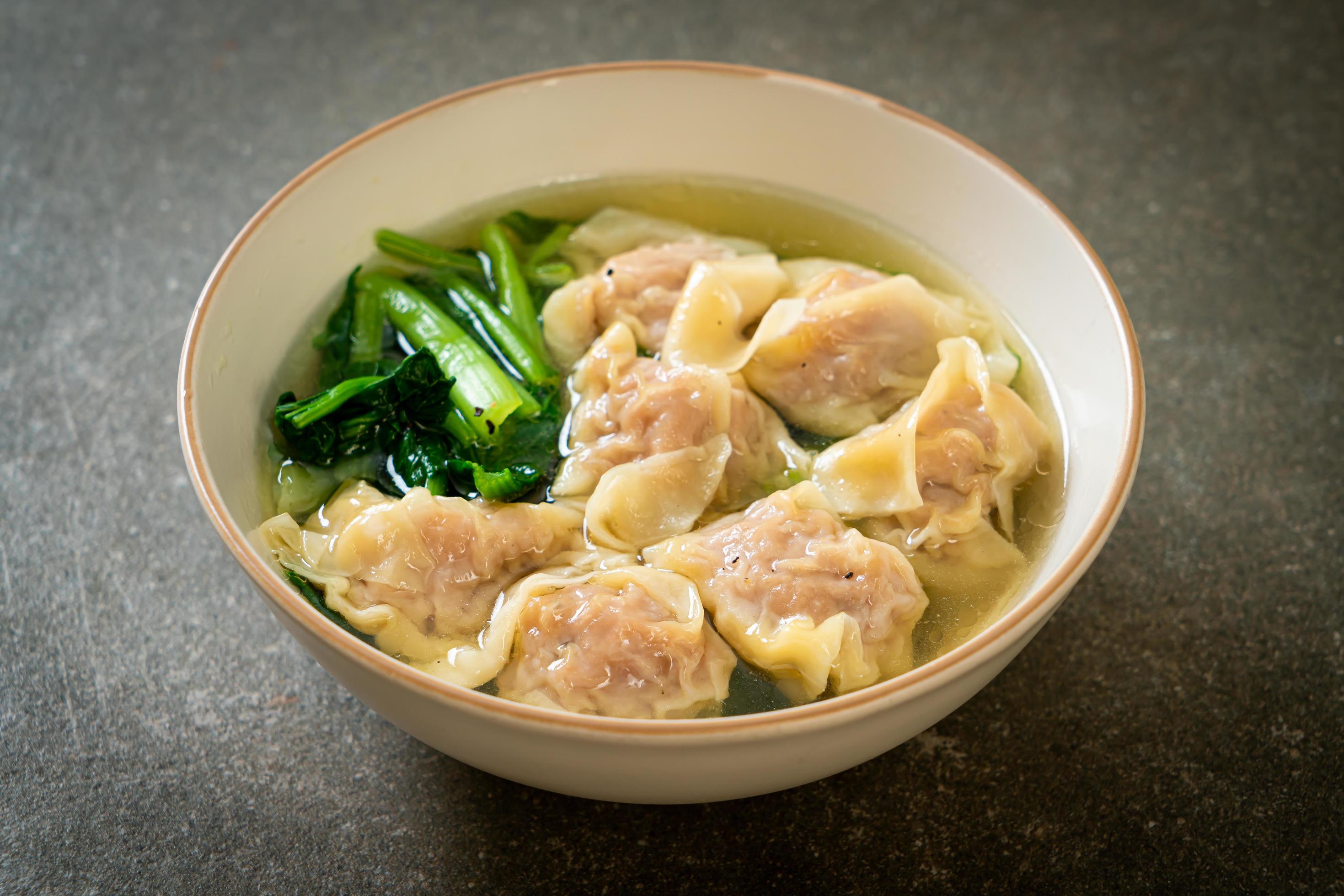 Pork wonton soup or pork dumpling soup with vegetables – Asian food style Stock Free