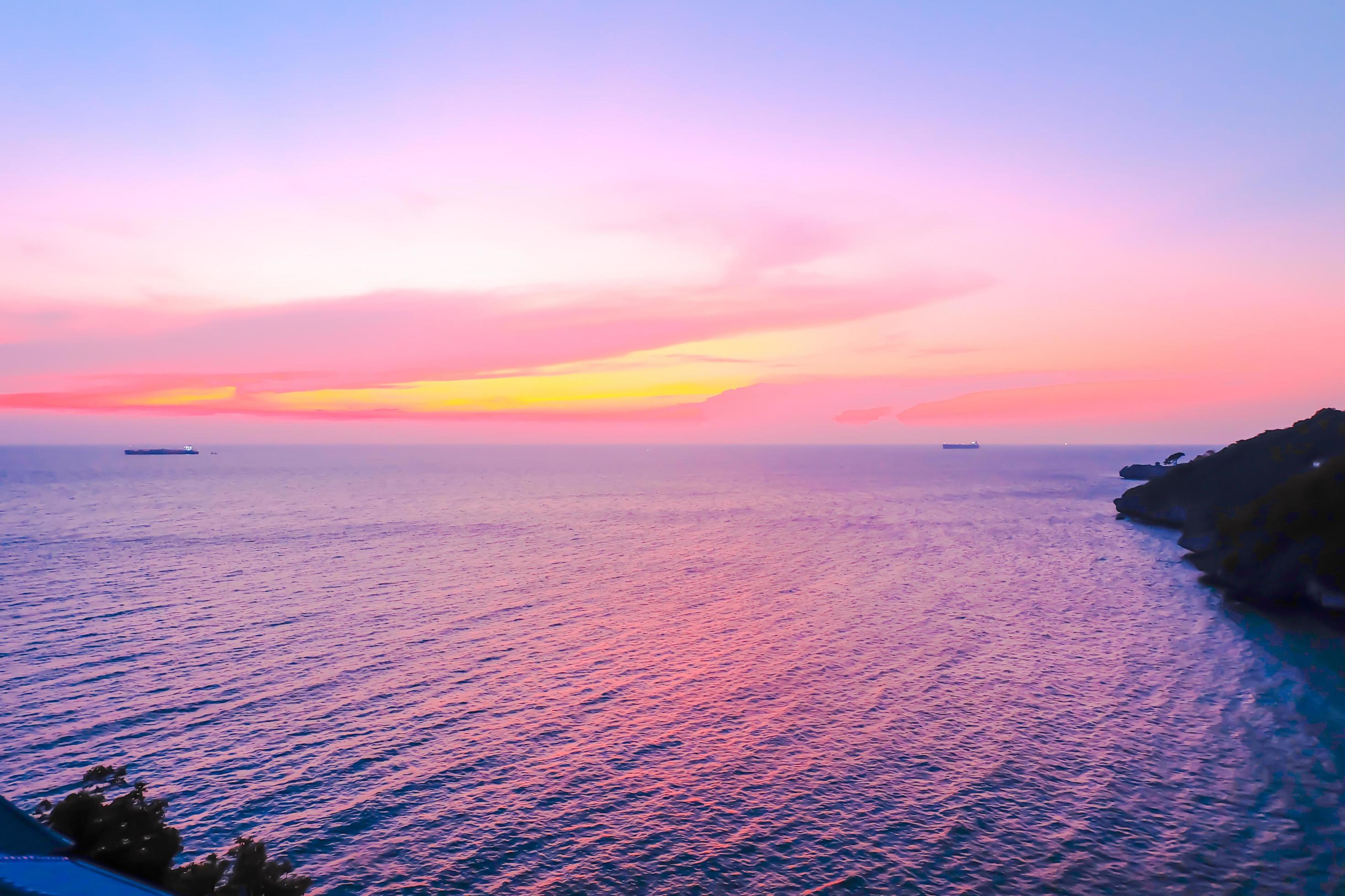 Colorfull sunset on the sea of Silhoutte Cargo Ship nature background Stock Free