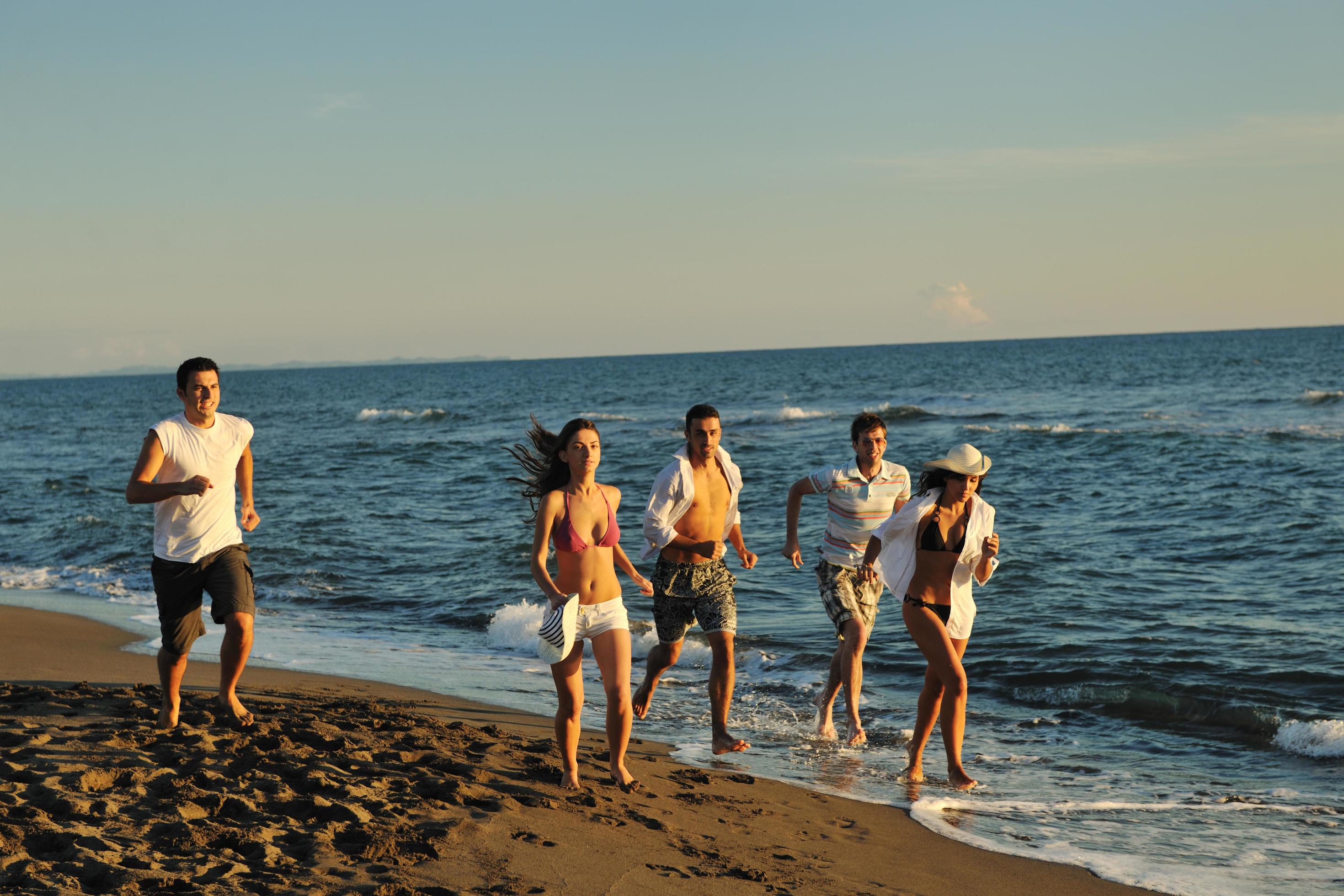 people group running on the beach Stock Free