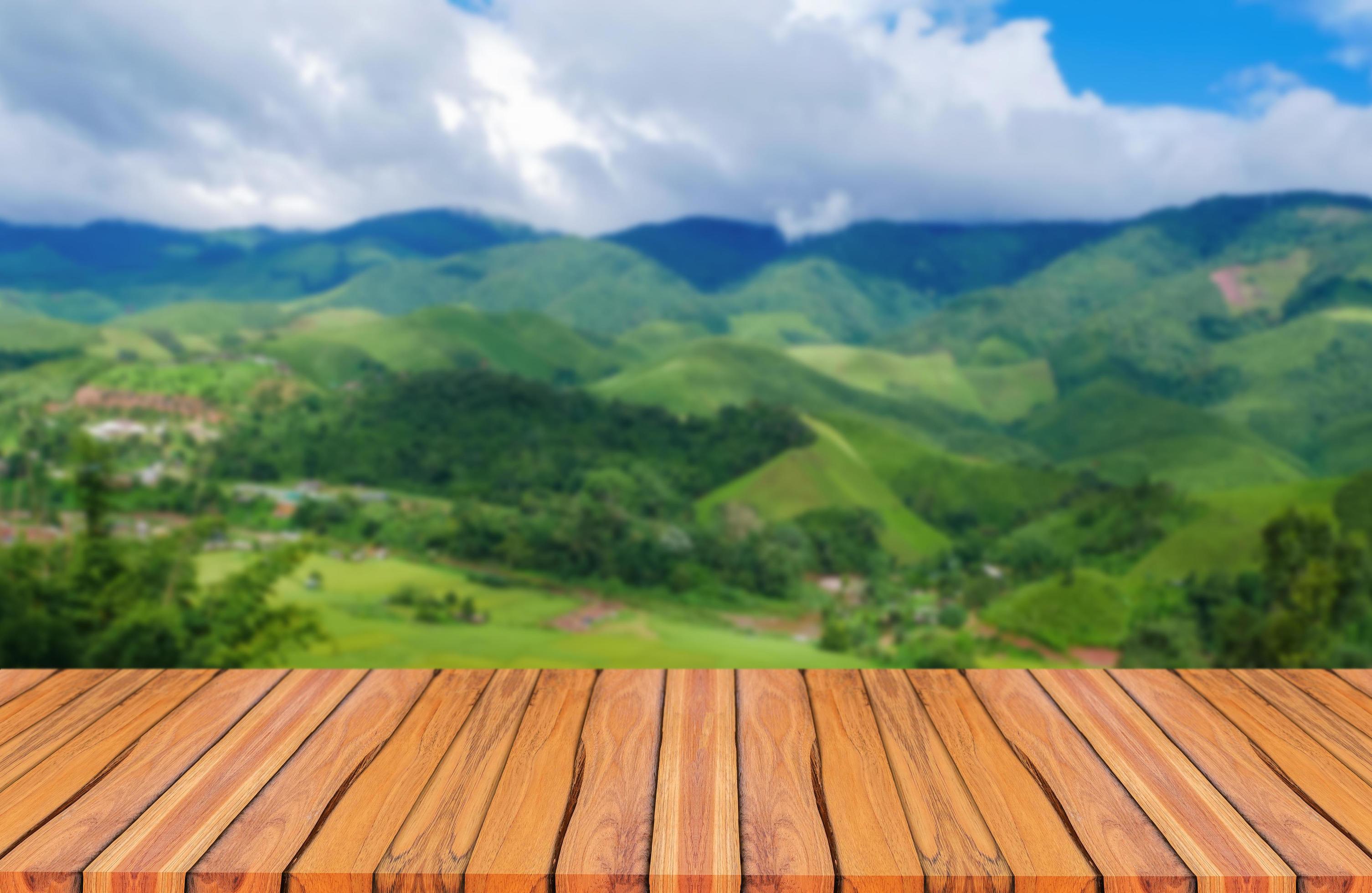 Natural wood floor, mountain background and blue sky. Stock Free