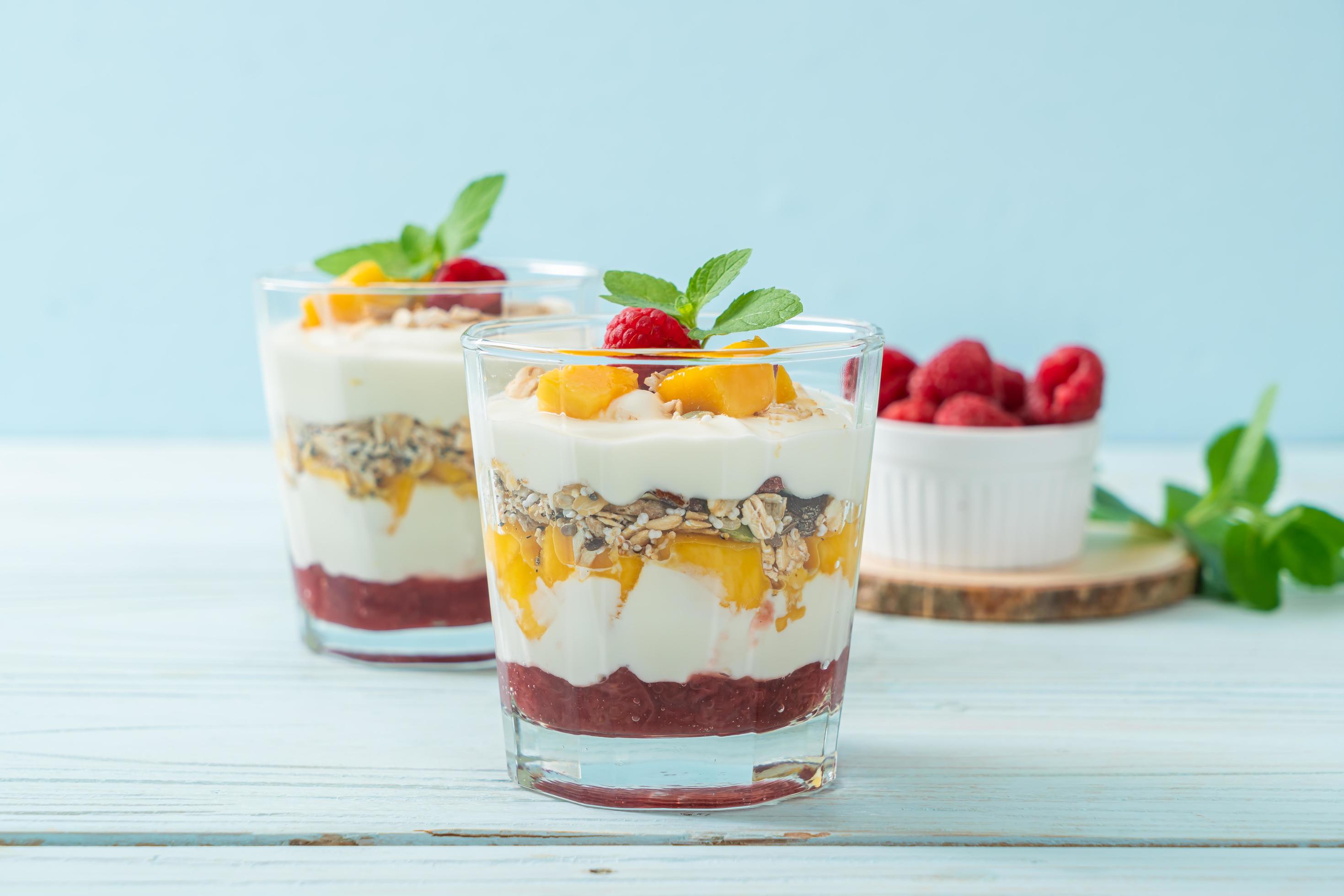 Homemade fresh mango and fresh raspberry with yogurt and granola – healthy food style Stock Free