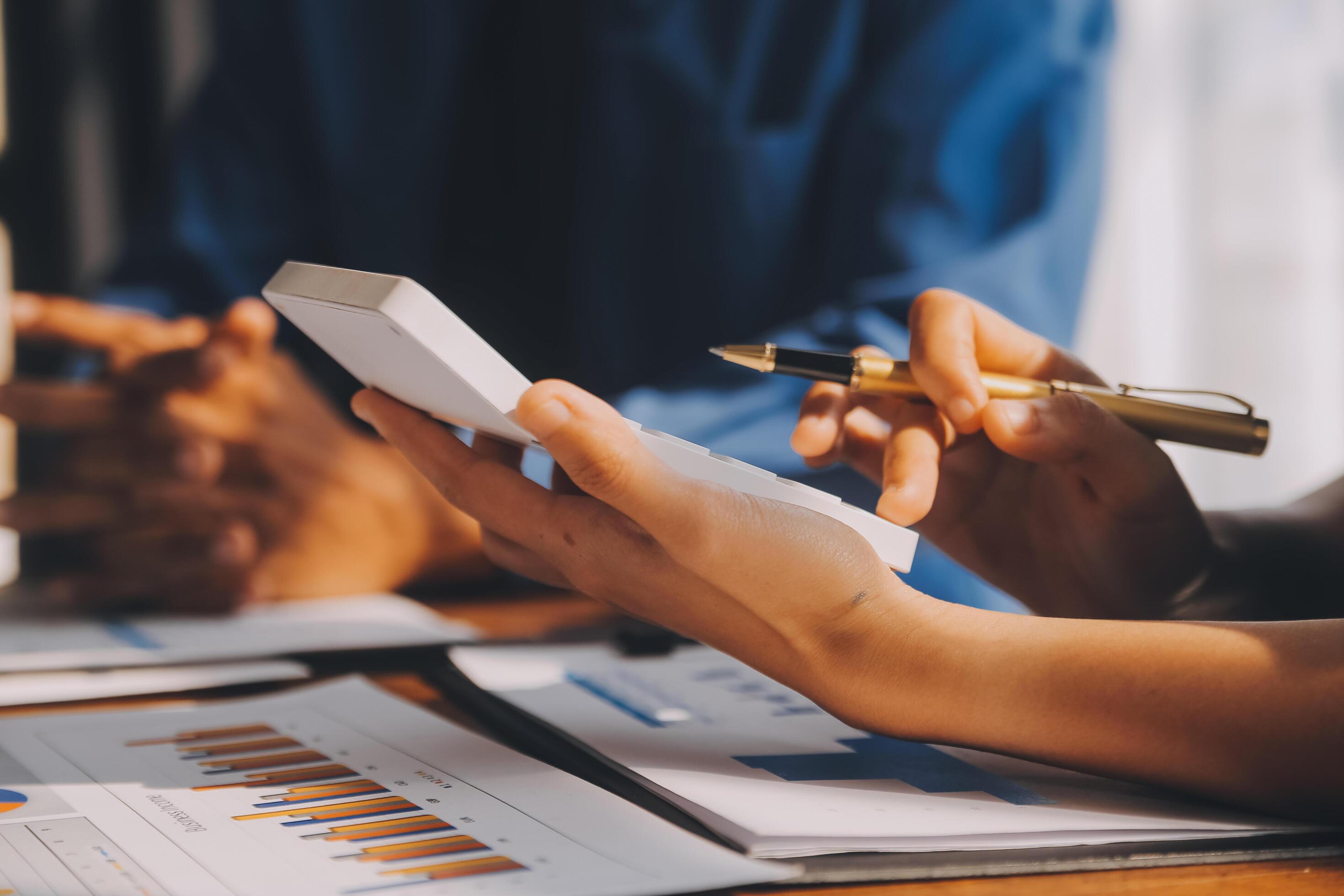 Close up of Business team analyzing income charts and graphs with modern laptop computer. Business analysis and strategy concept. Stock Free