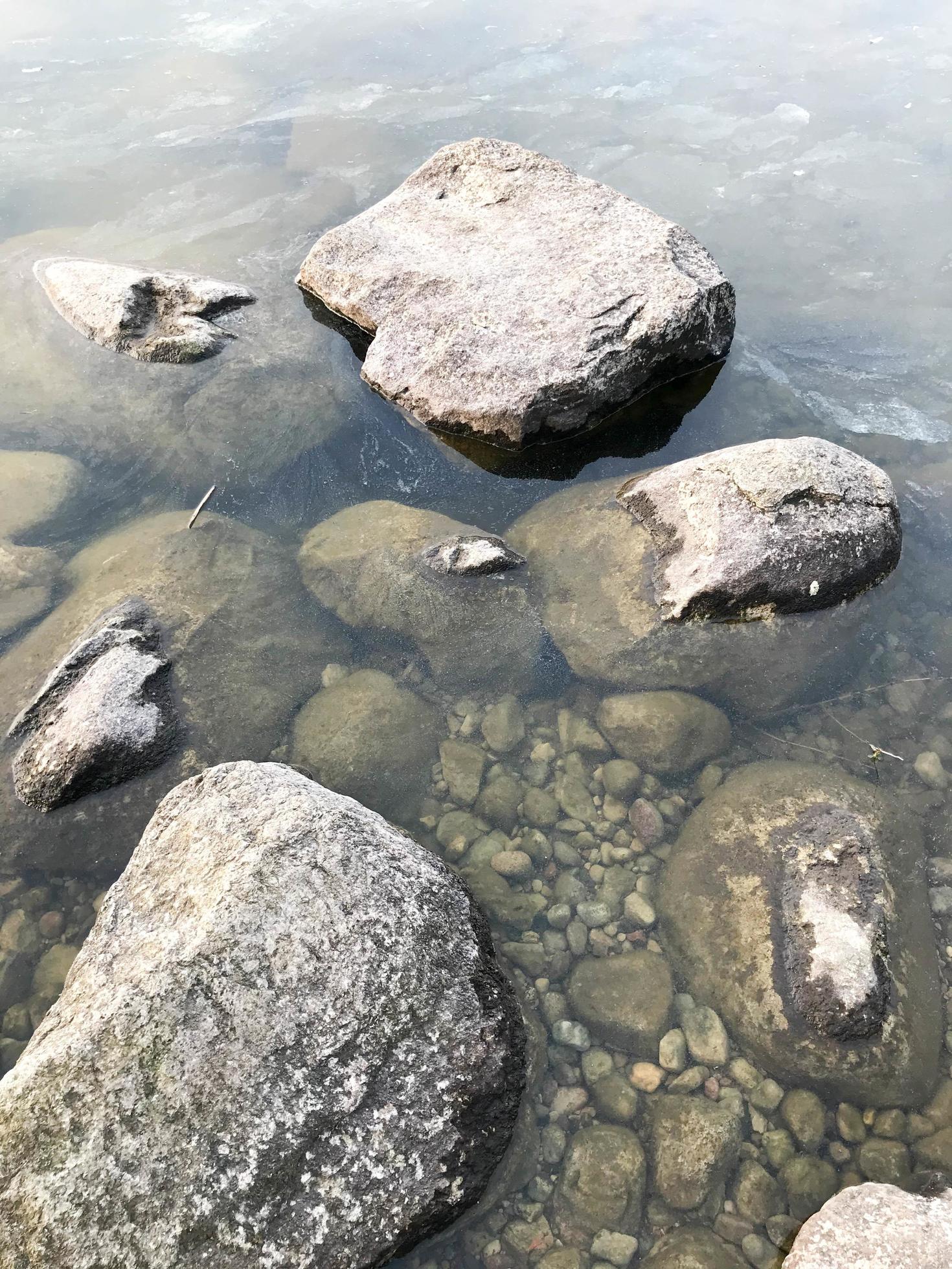 Large round beautiful natural stones cobblestones in water, sea, lake, river. Background, texture Stock Free