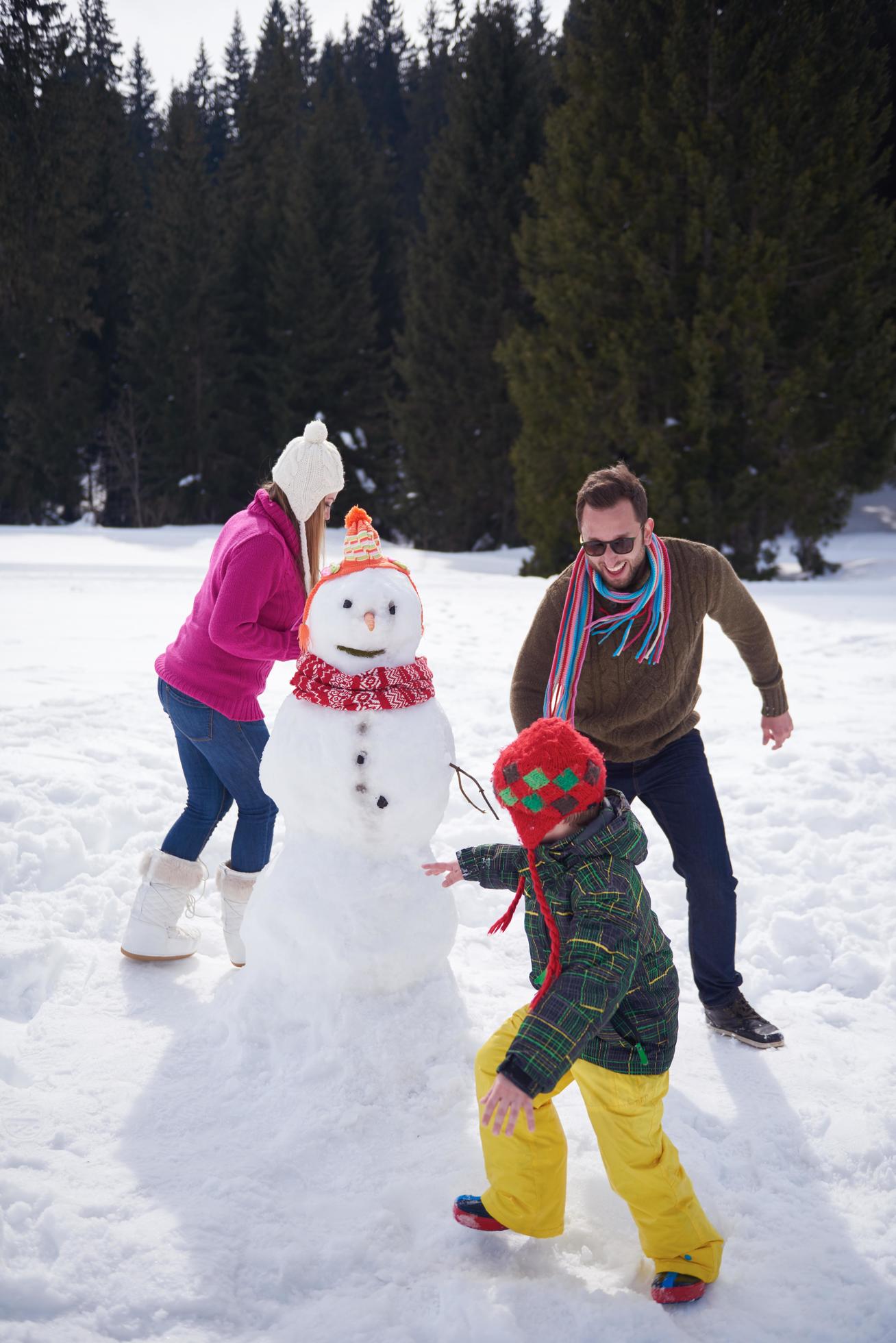 happy family building snowman Stock Free