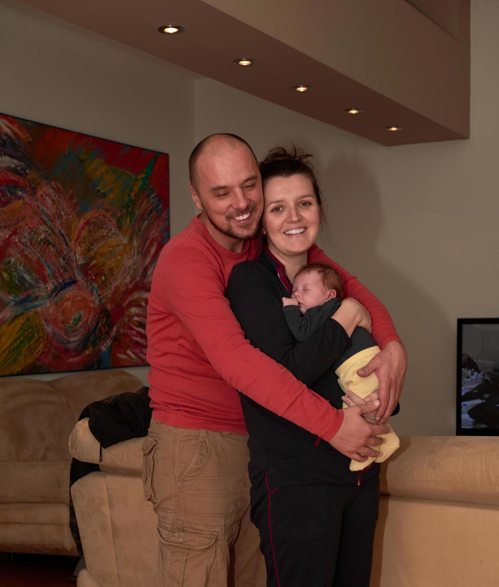 young family portrait with newborn baby Stock Free