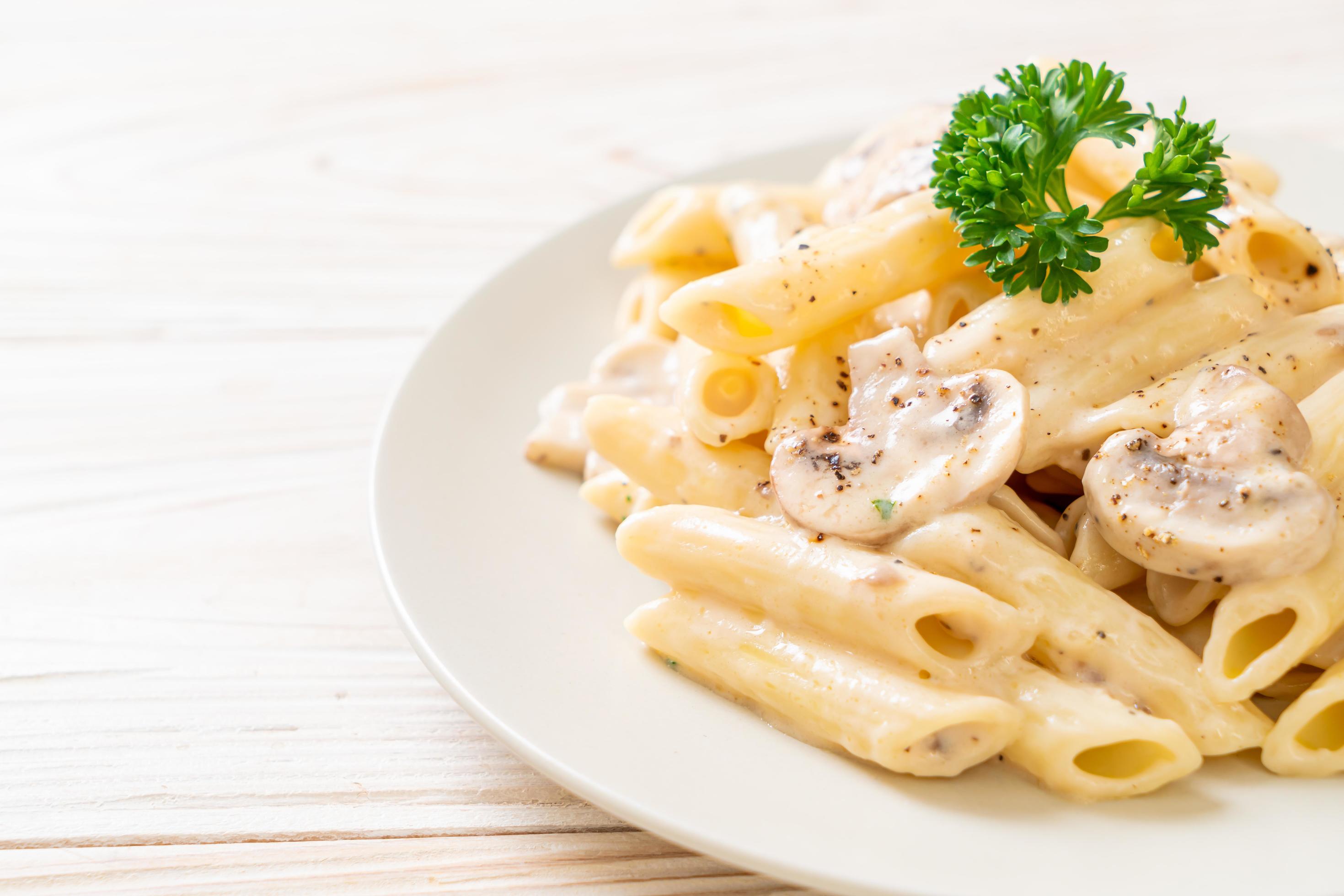 Penne pasta carbonara cream sauce with mushroom – Italian food style Stock Free