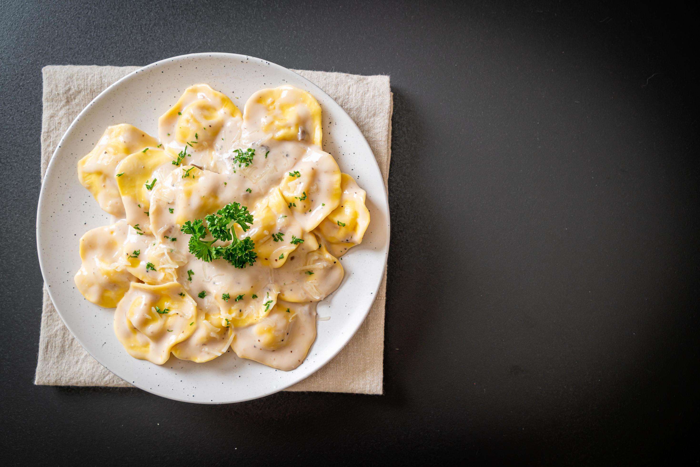 Ravioli pasta with mushroom cream sauce and cheese – Italian food style Stock Free