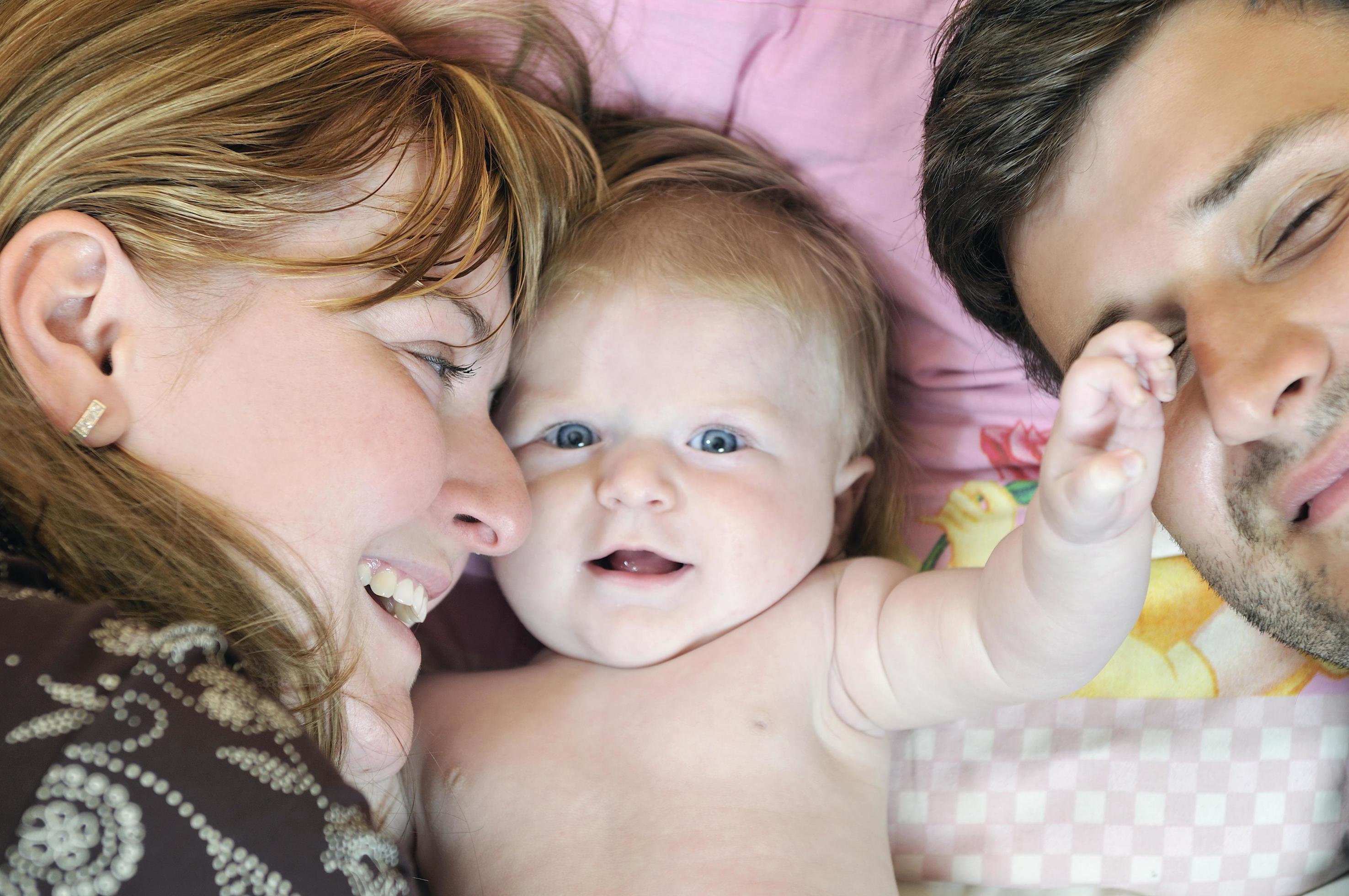 portrait of young family with cute little babby Stock Free