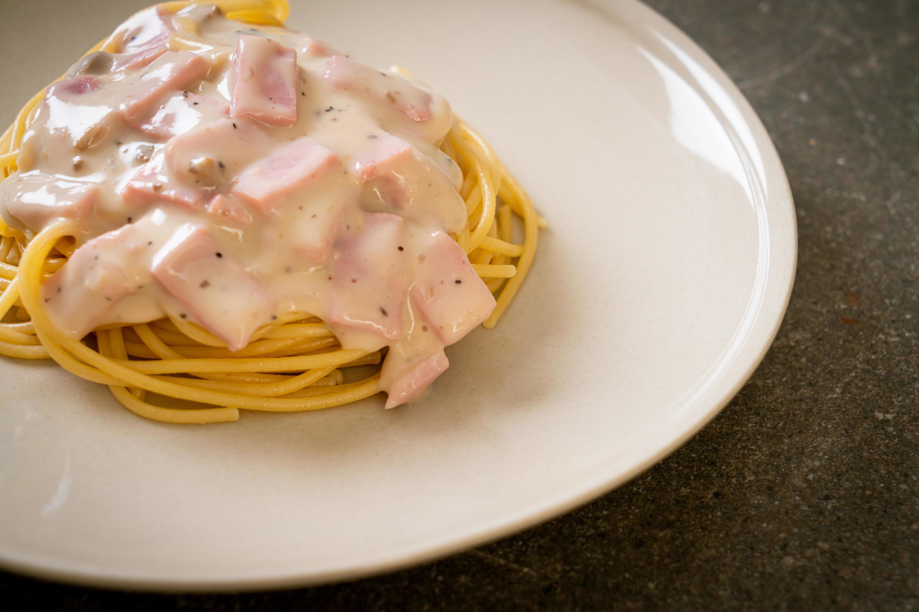 Homemade spaghetti white cream sauce with ham – Italian food style Stock Free