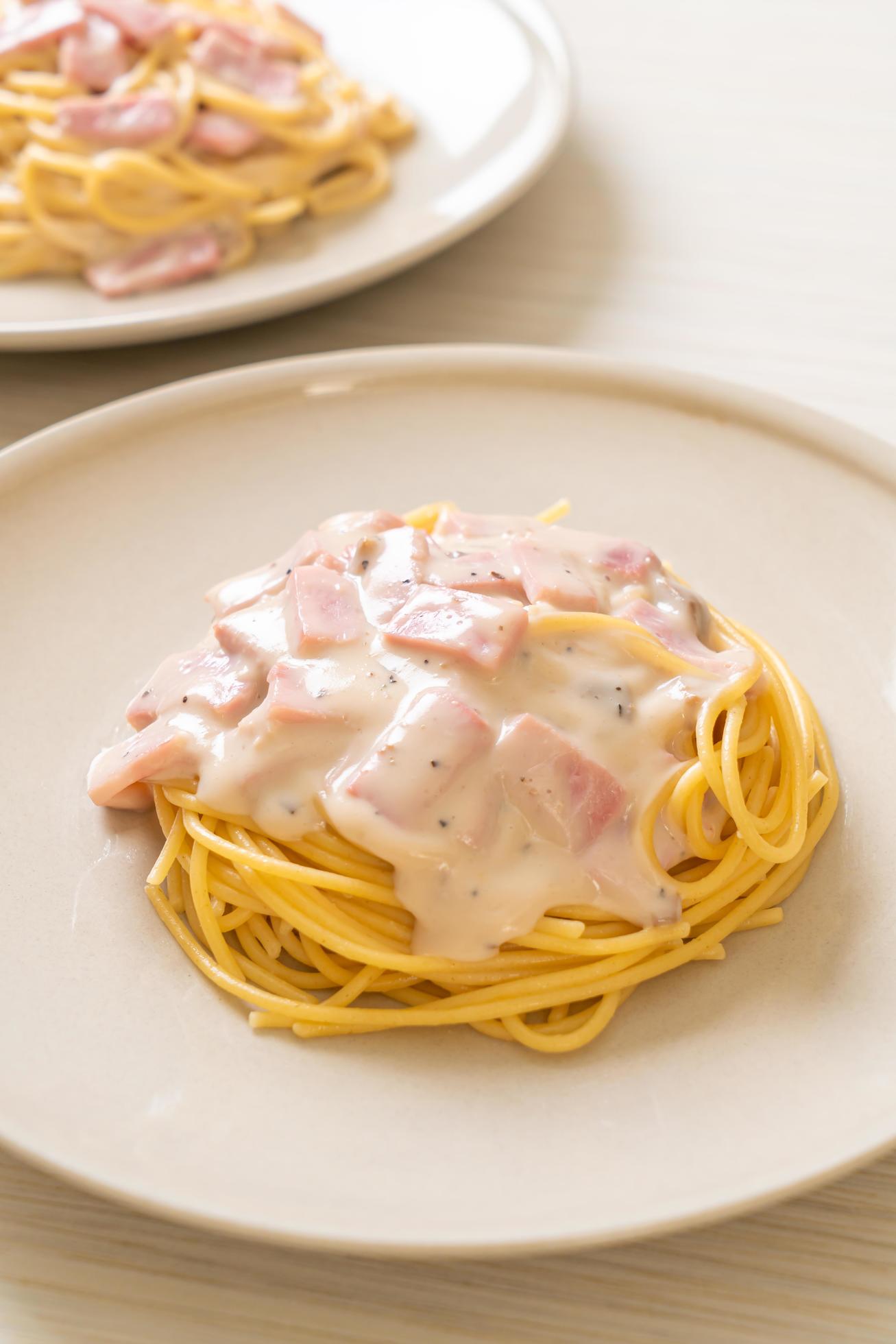 Homemade spaghetti white cream sauce with ham – Italian food style Stock Free