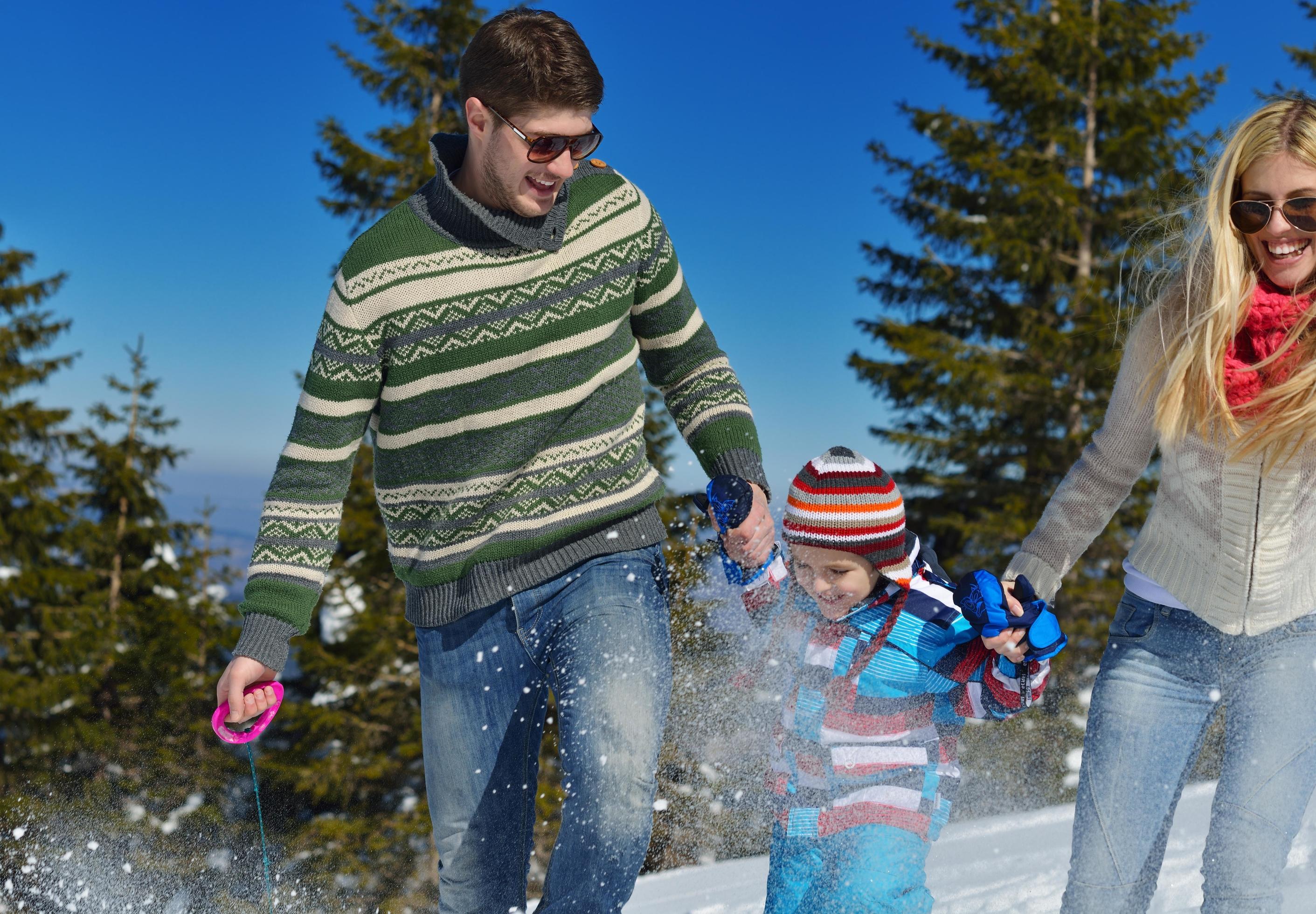 family having fun on fresh snow at winter Stock Free