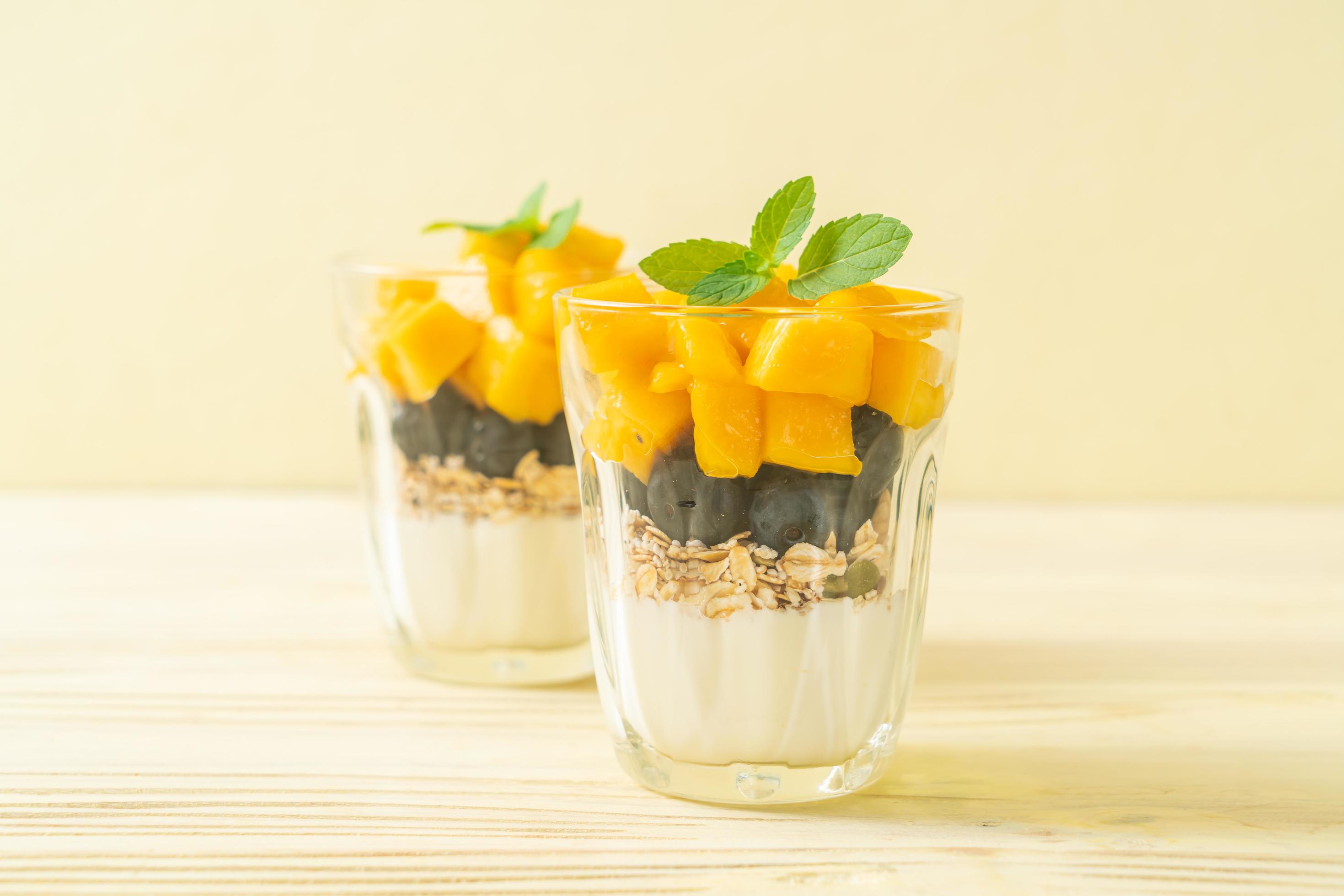 Homemade fresh mango and fresh blueberry with yogurt and granola – healthy food style Stock Free