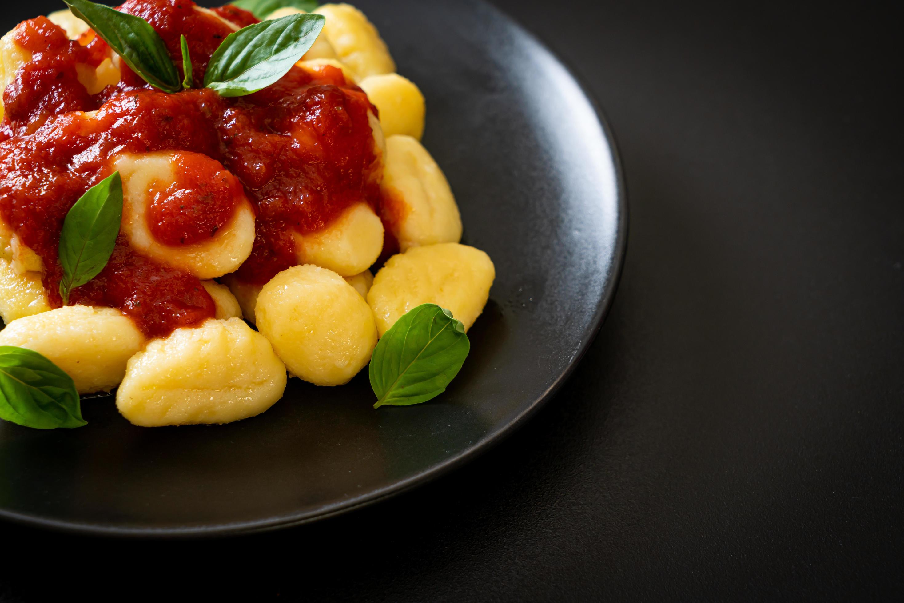 Gnocchi in tomato sauce with cheese – Italian food style Stock Free