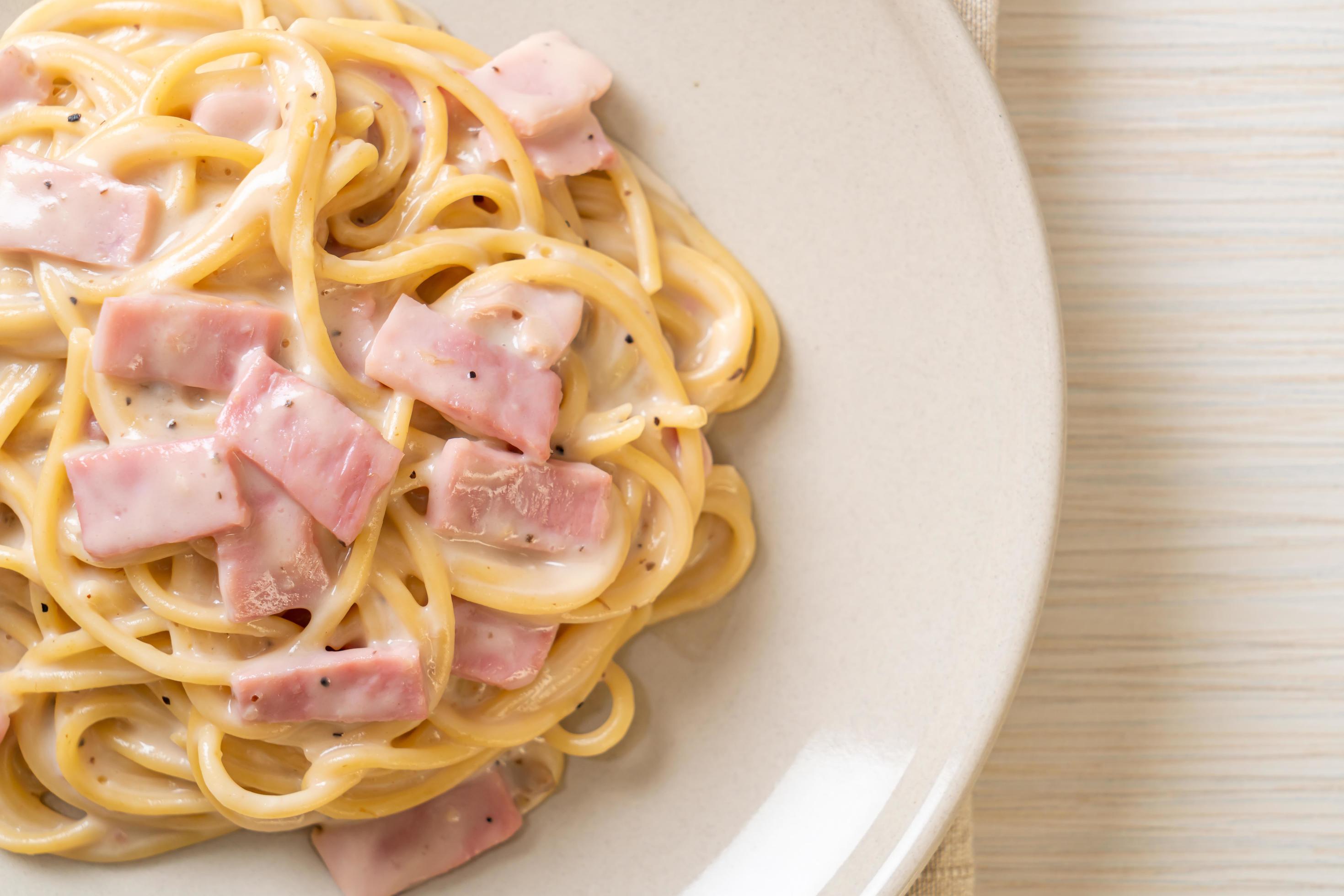 Homemade spaghetti white cream sauce with ham – Italian food style Stock Free