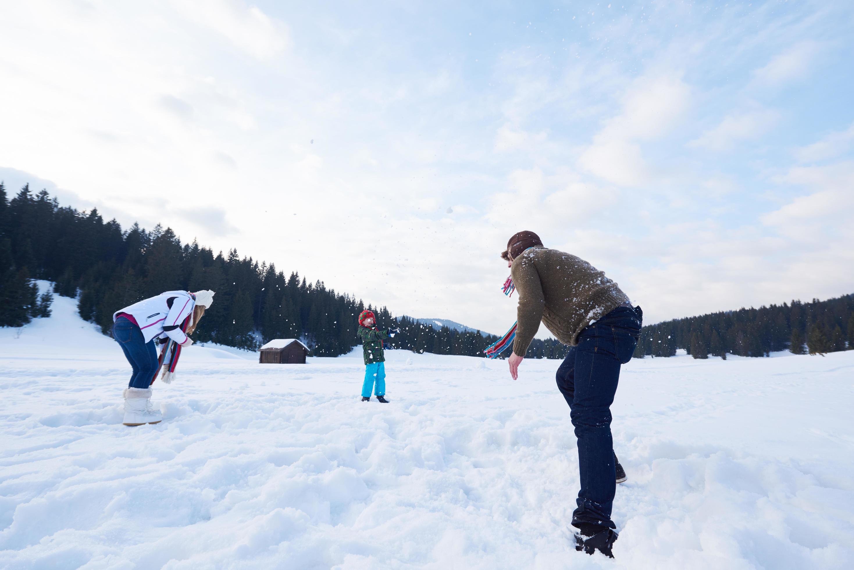 happy family playing together in snow at winter Stock Free