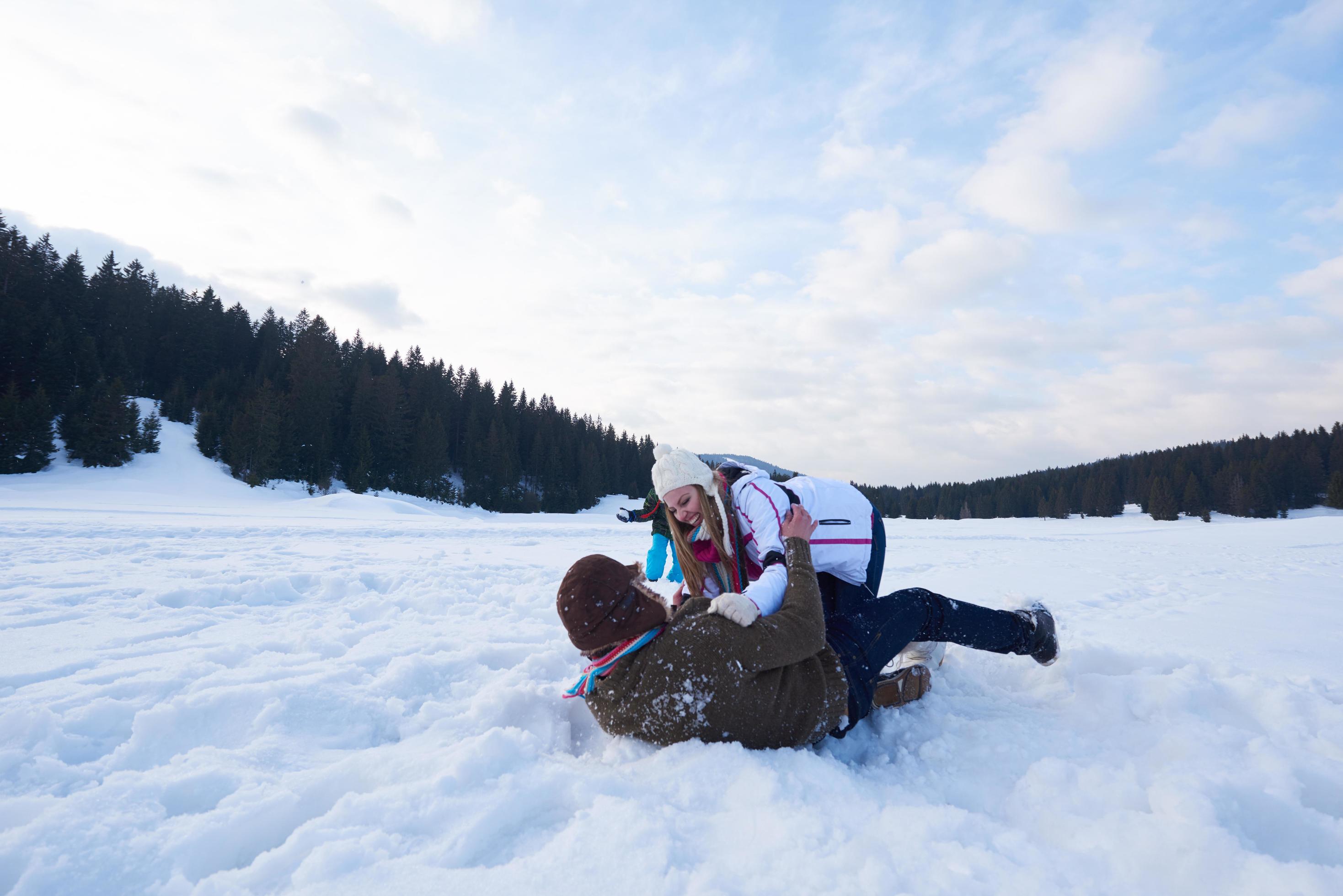 happy family playing together in snow at winter Stock Free