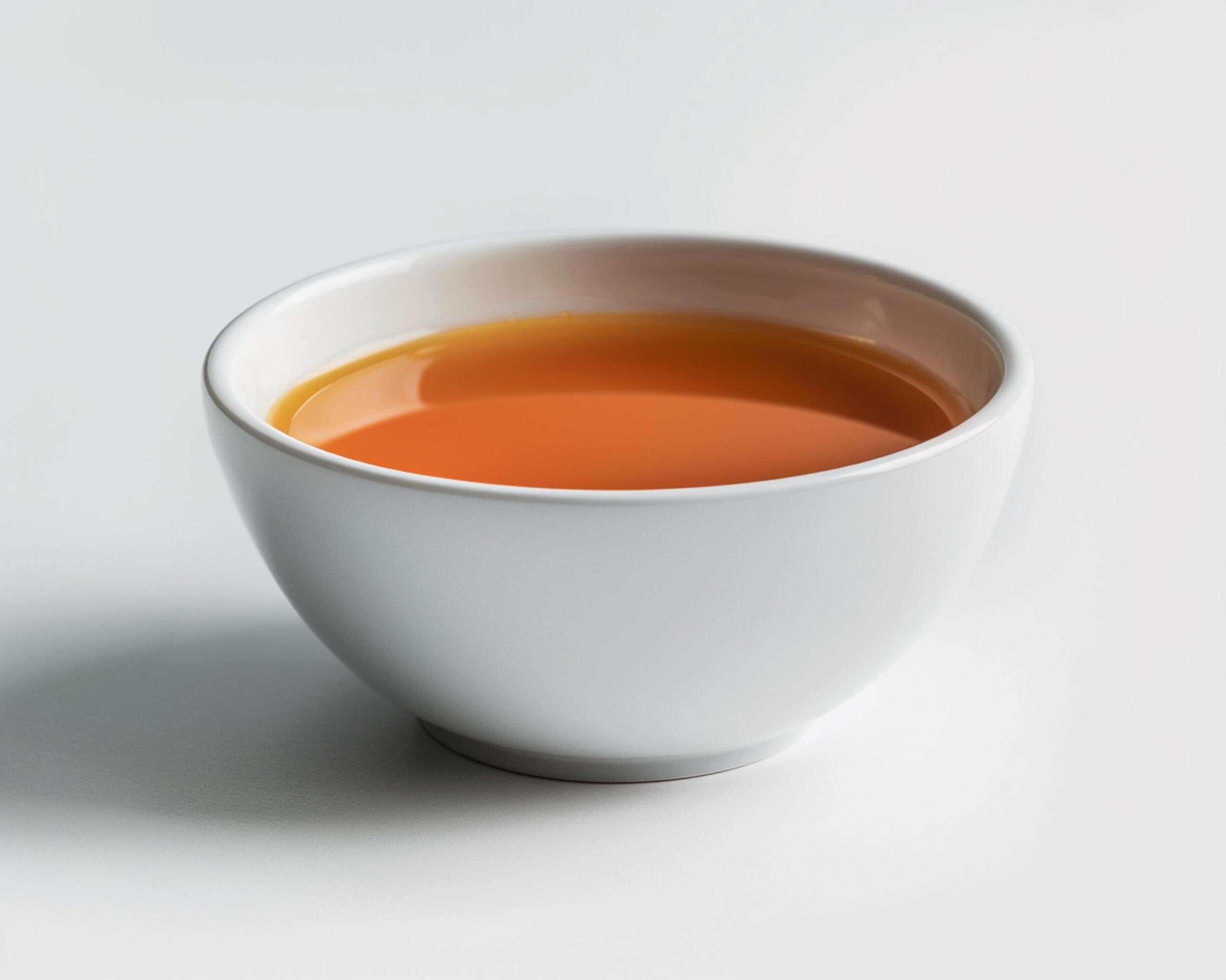 a white bowl of tea on a white background Stock Free