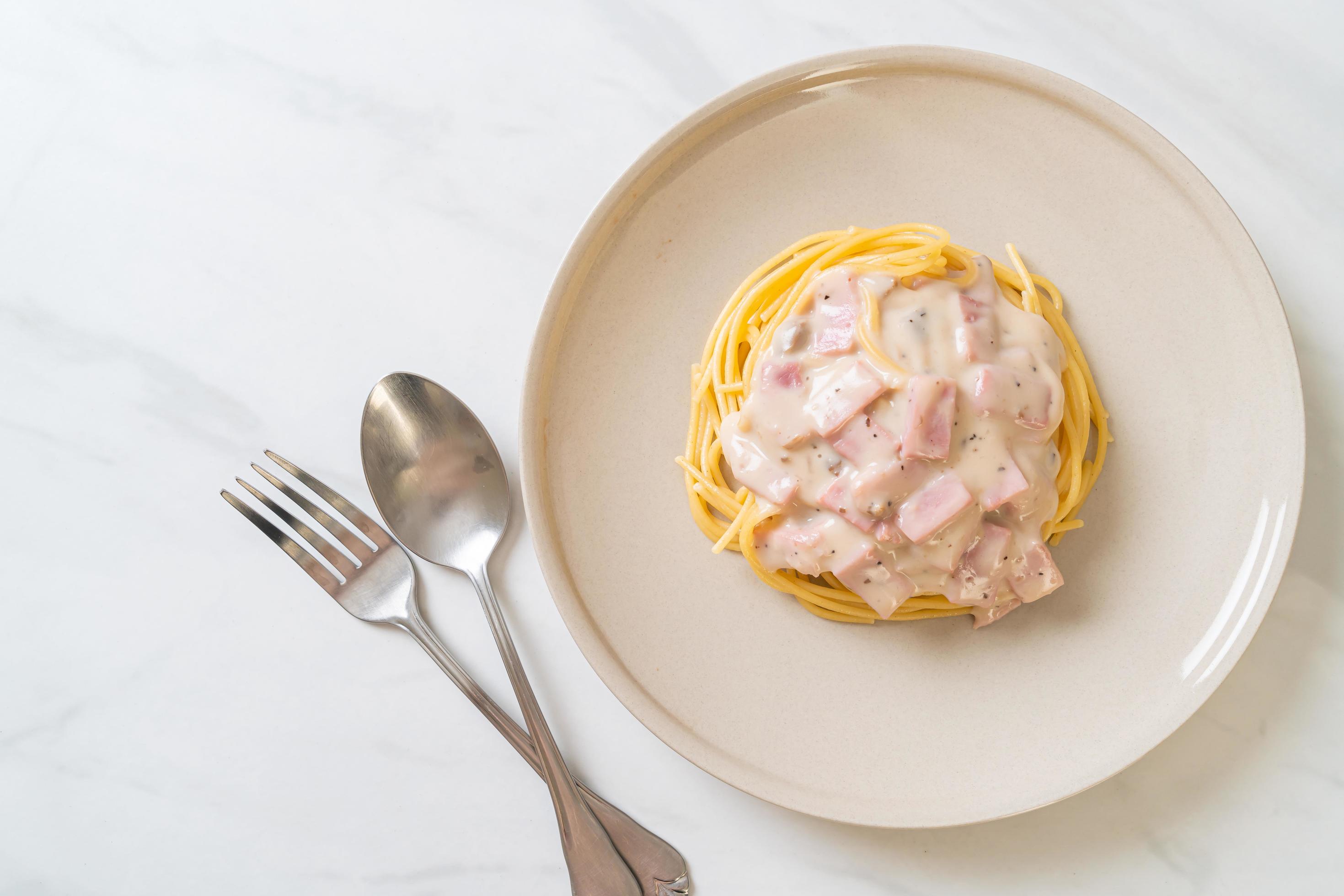 Homemade spaghetti white cream sauce with ham – Italian food style Stock Free