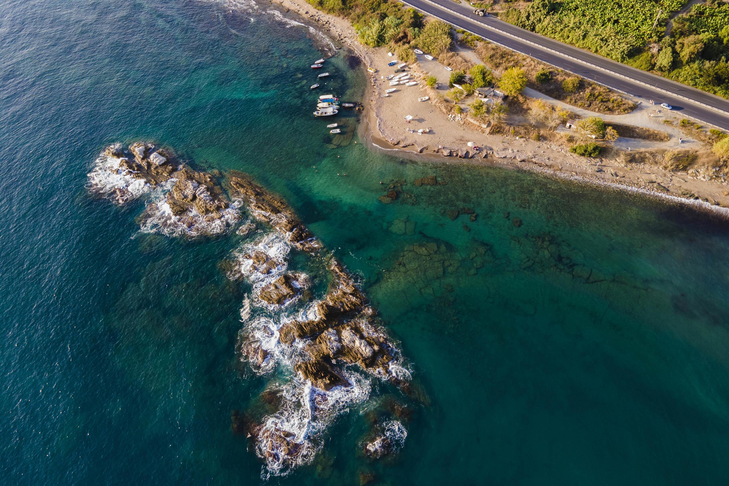 from the air. Waves float to the rocky shore. Stock Free