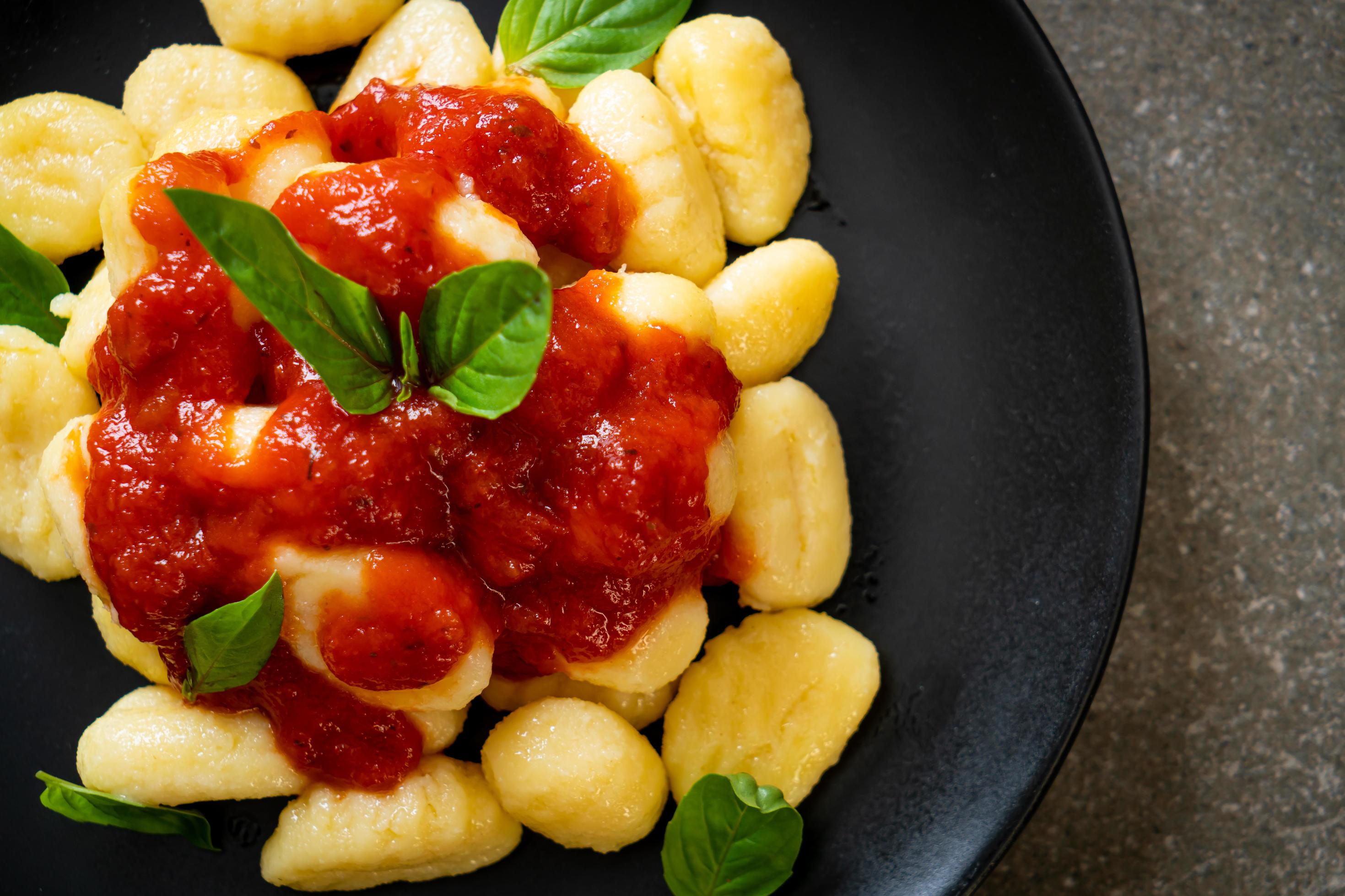 Gnocchi in tomato sauce with cheese – Italian food style Stock Free