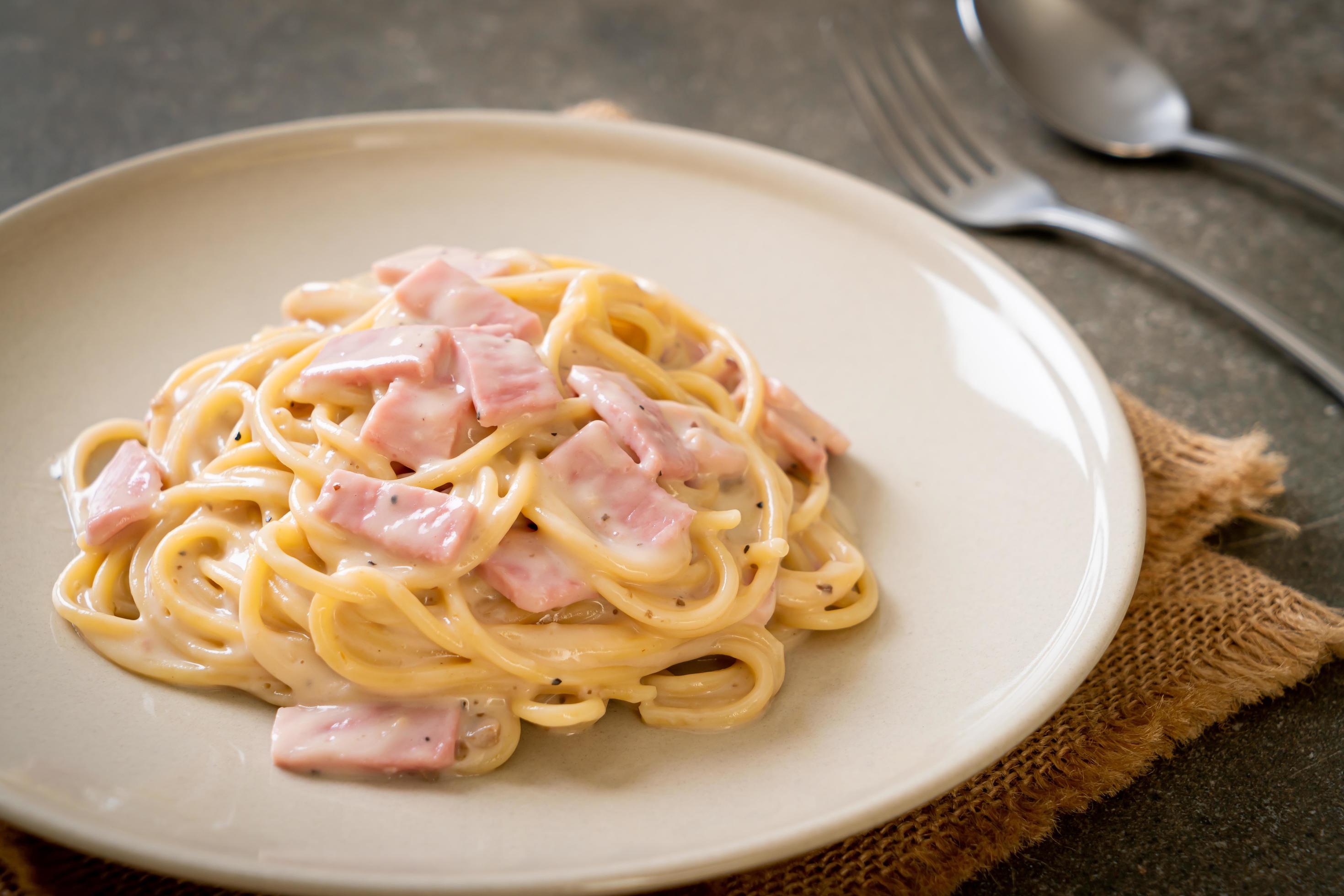 Homemade spaghetti white cream sauce with ham – Italian food style Stock Free