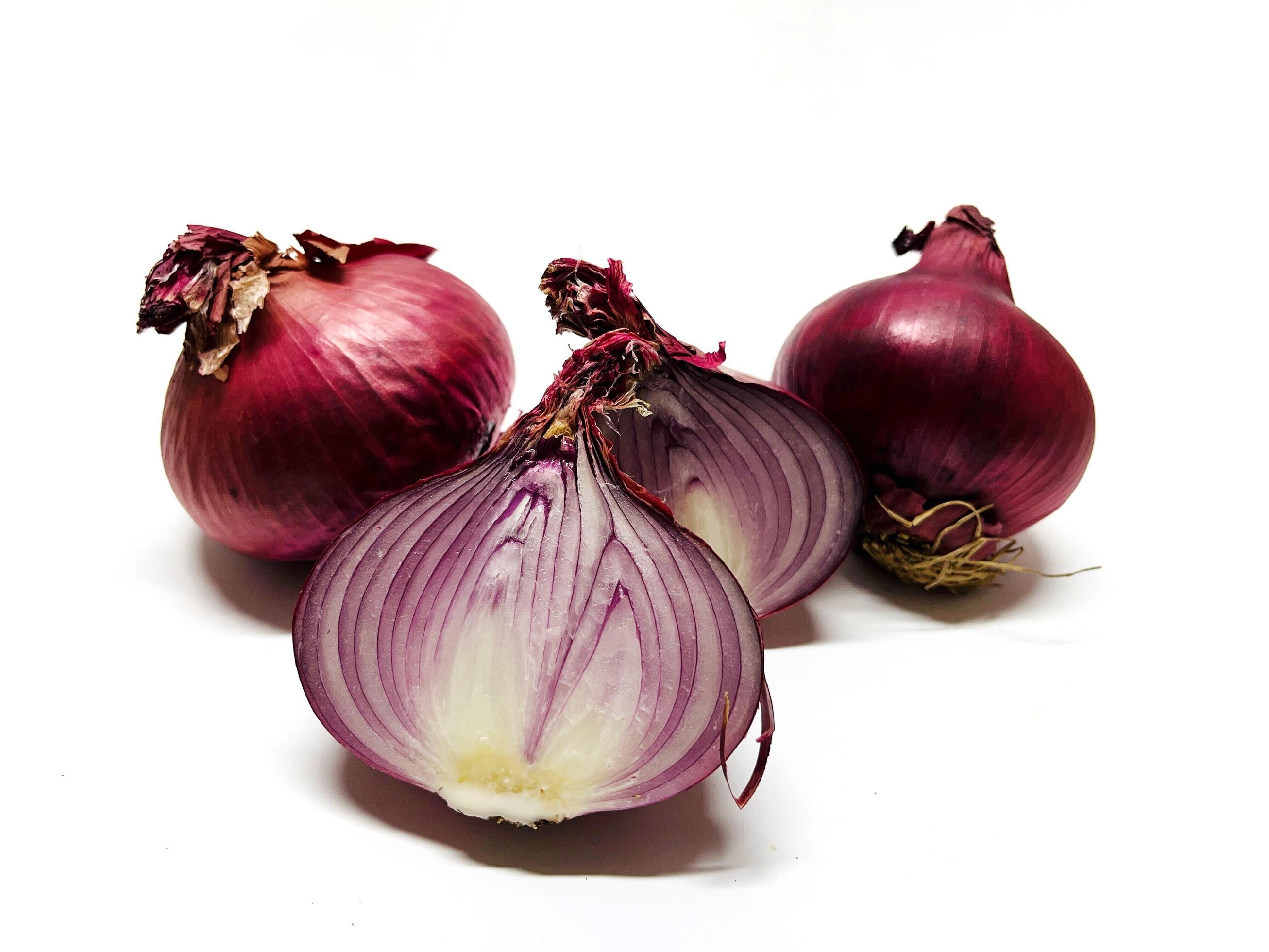 Red whole and sliced onion, isolated on white background. Big red onion Stock Free