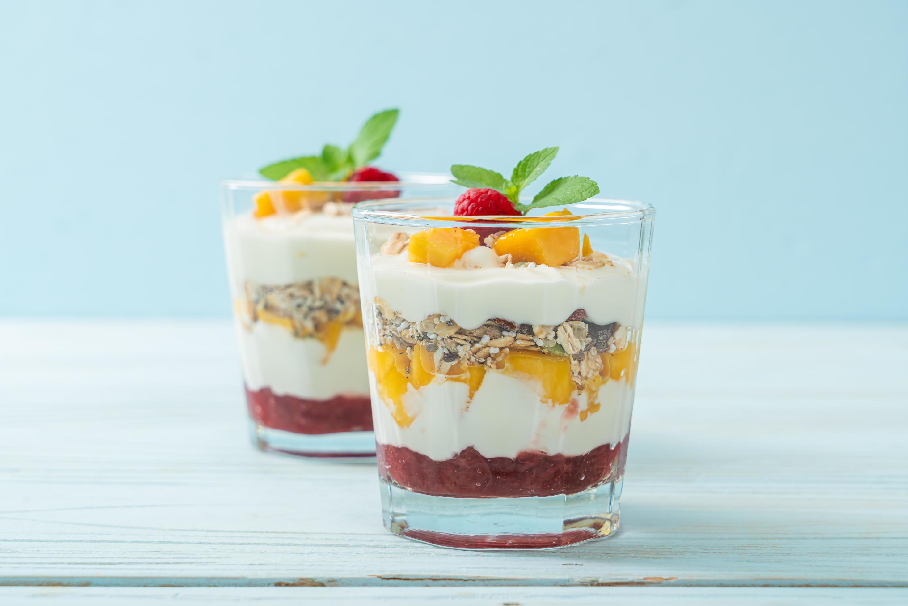 Homemade fresh mango and fresh raspberry with yogurt and granola – healthy food style Stock Free