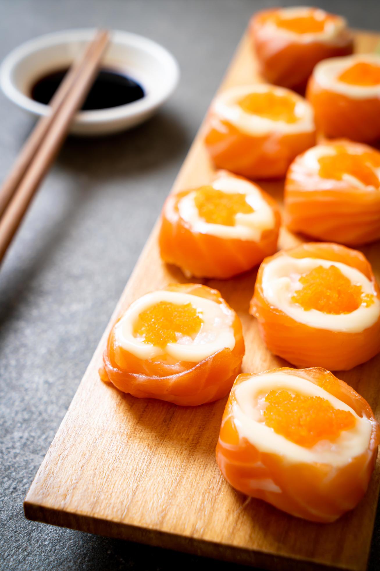 Fresh salmon sushi roll with mayonnaise and shrimp egg – Japanese food style Stock Free