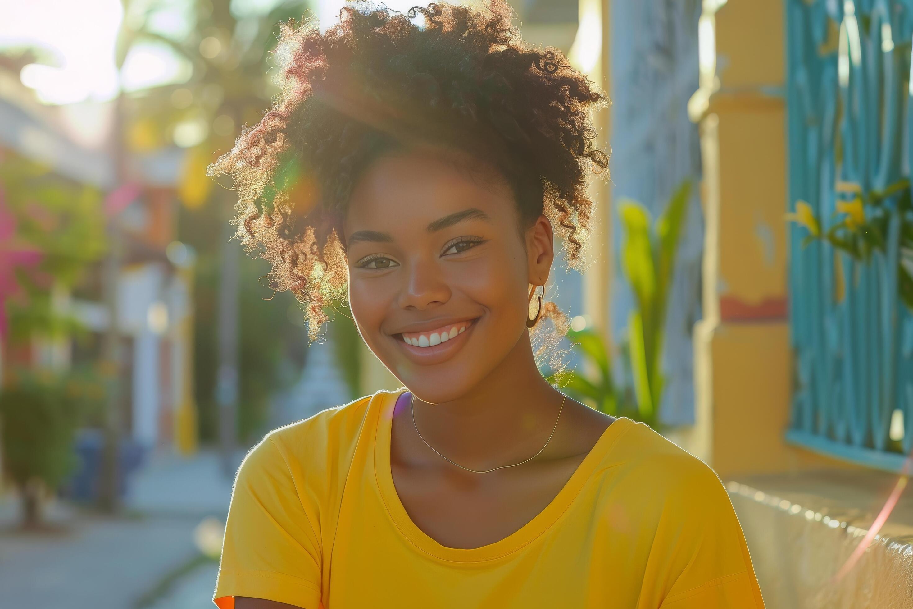 Smiling Woman With Dreadlocks in a Yellow Shirt on a Street in a City Stock Free