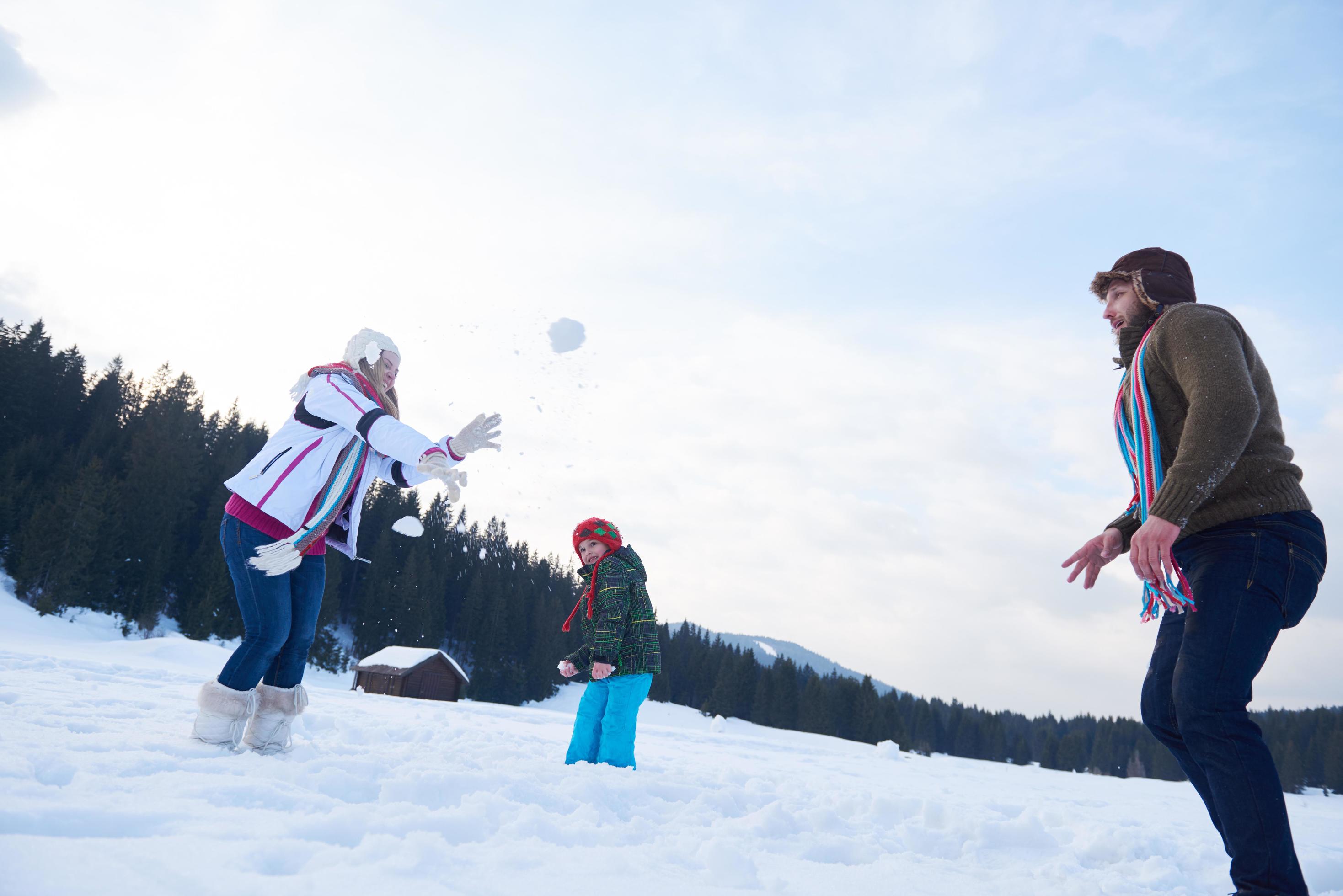 happy family playing together in snow at winter Stock Free