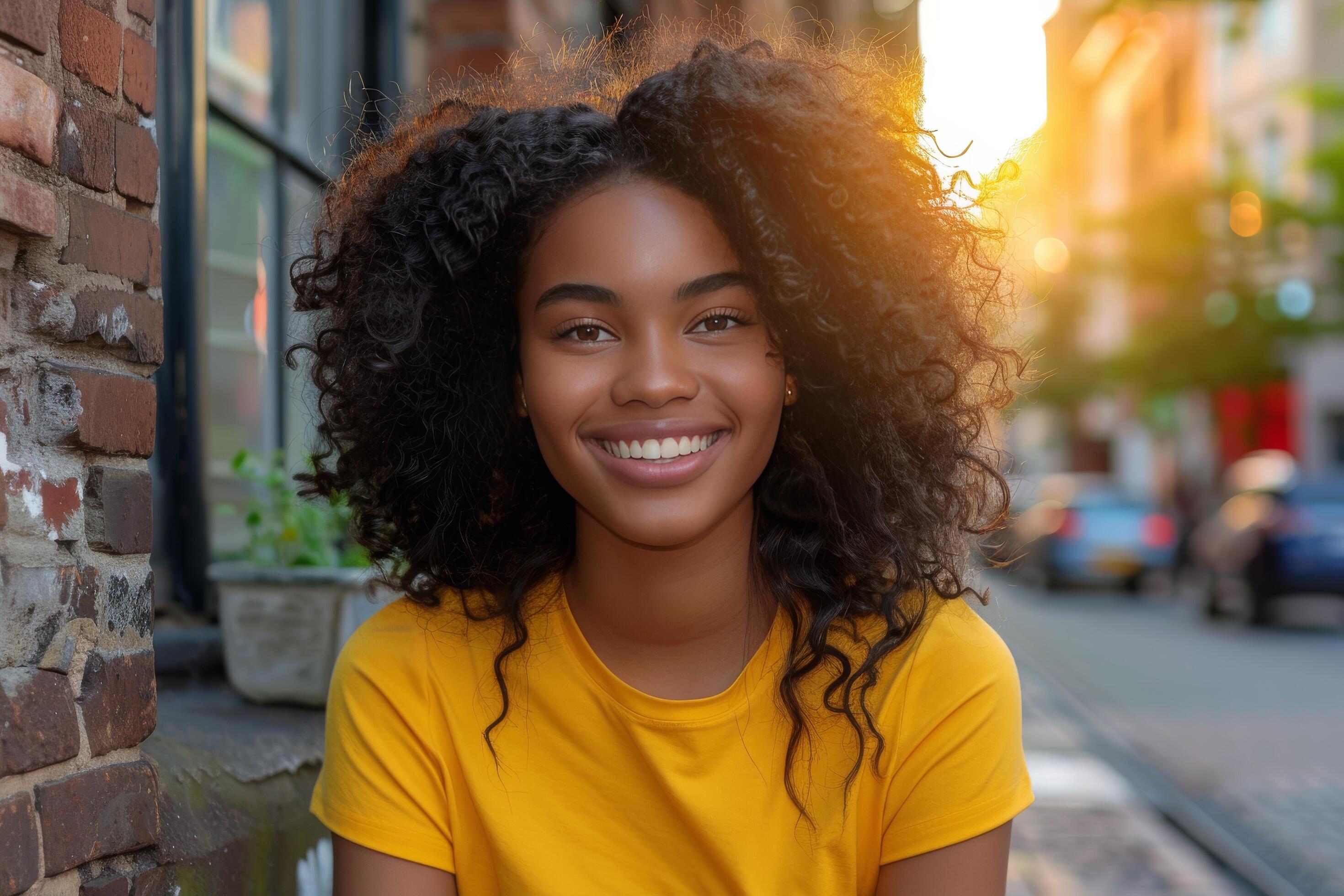 Smiling Woman With Dreadlocks in a Yellow Shirt on a Street in a City Stock Free