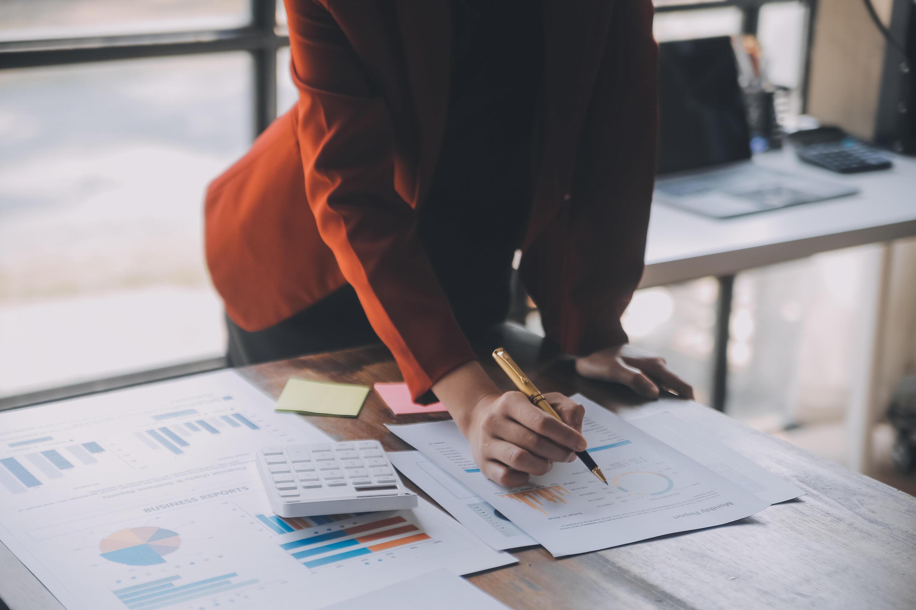 Close up of Business team analyzing income charts and graphs with modern laptop computer. Business analysis and strategy concept. Stock Free