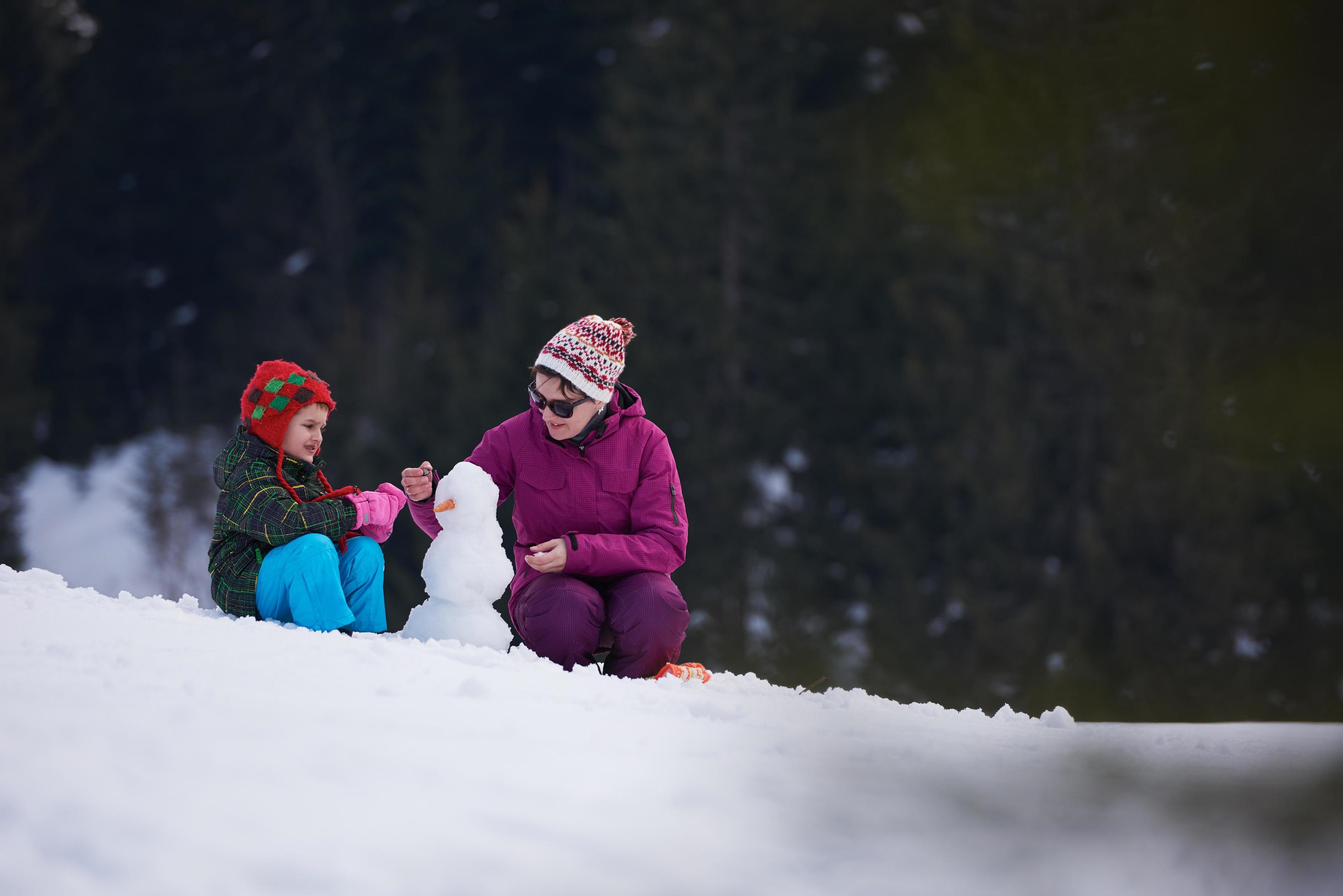 happy family building snowman Stock Free