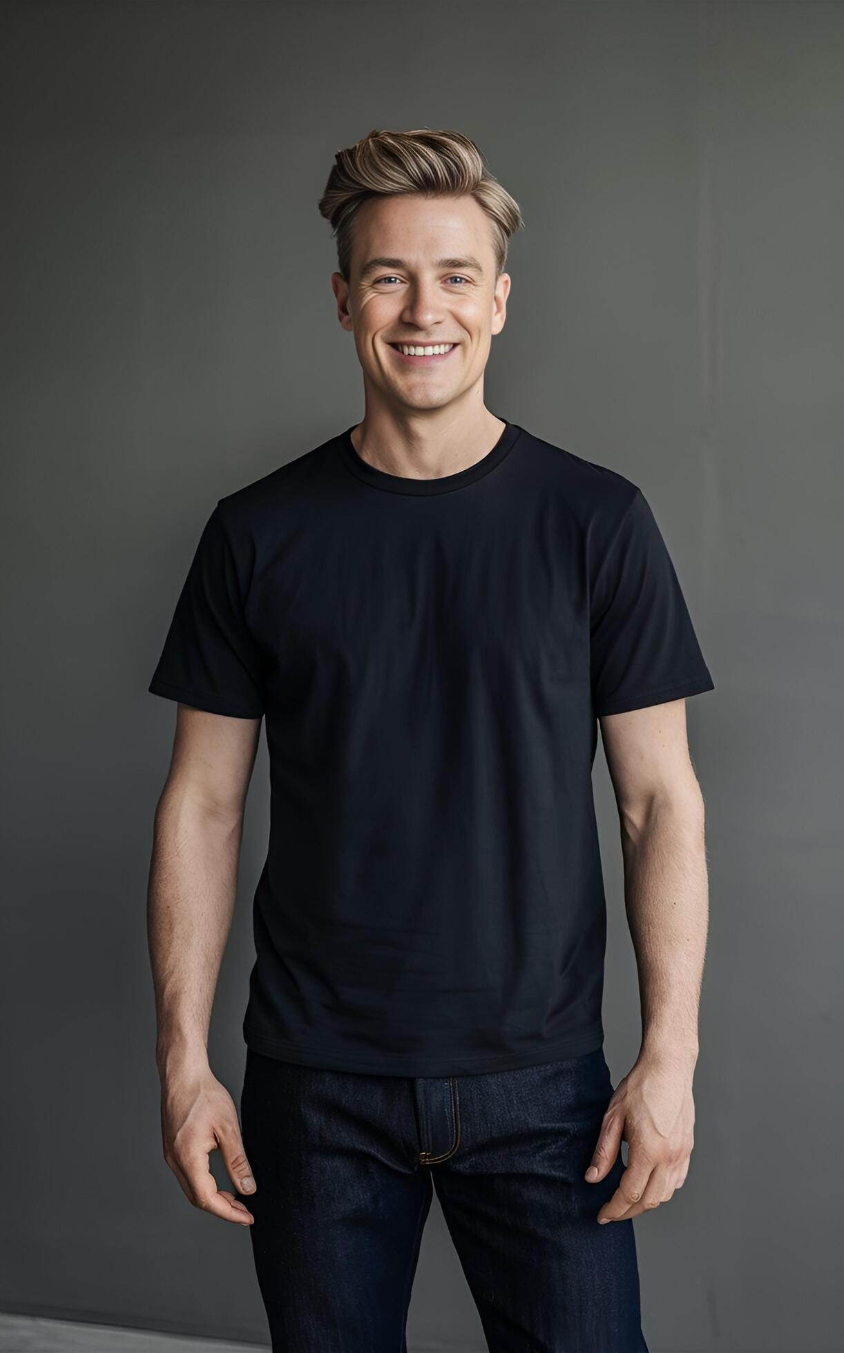 
									A portrait of a man in a black t-shirt and jeans, standing against a neutral grey background. Stock Free