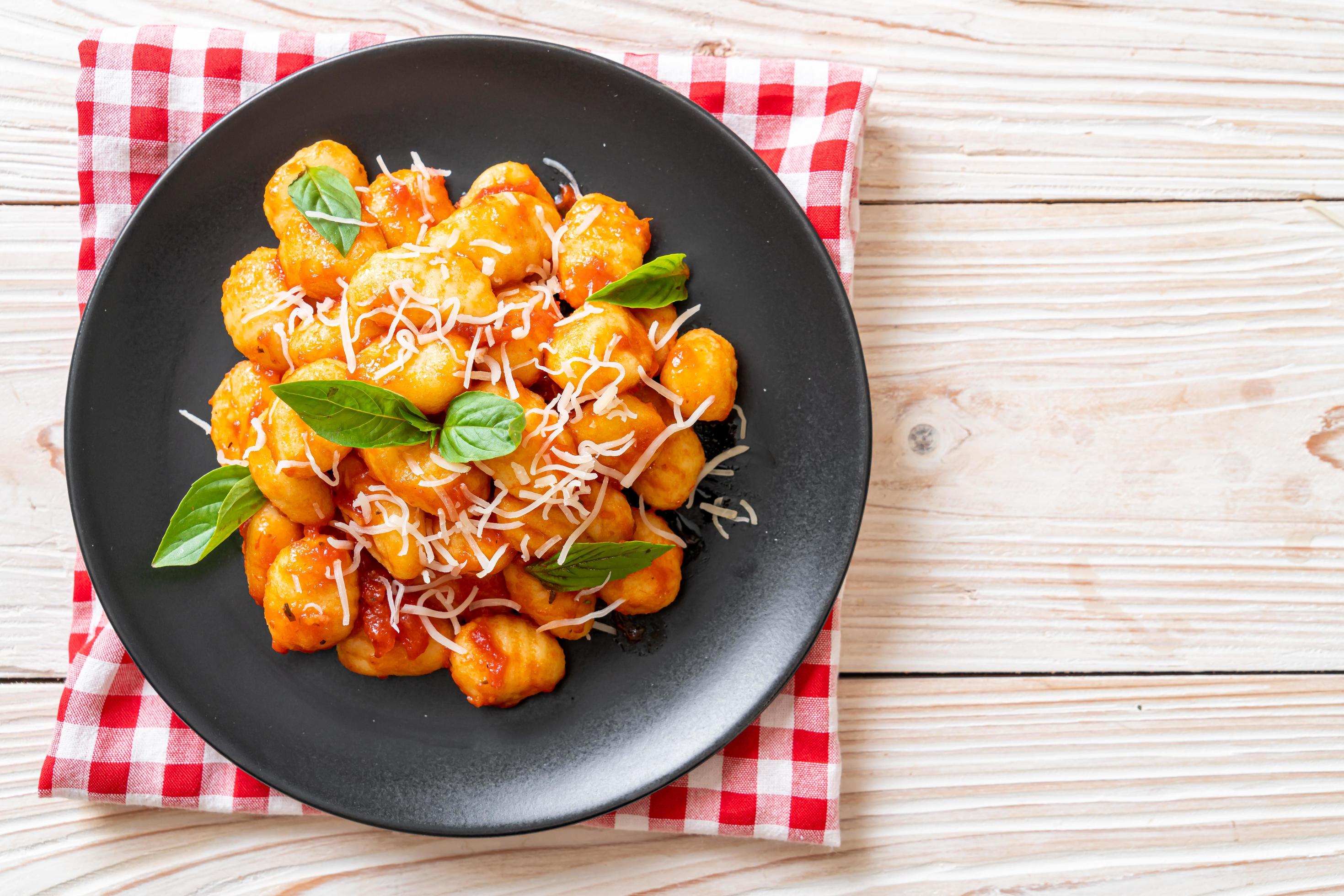 Gnocchi in tomato sauce with cheese – Italian food style Stock Free