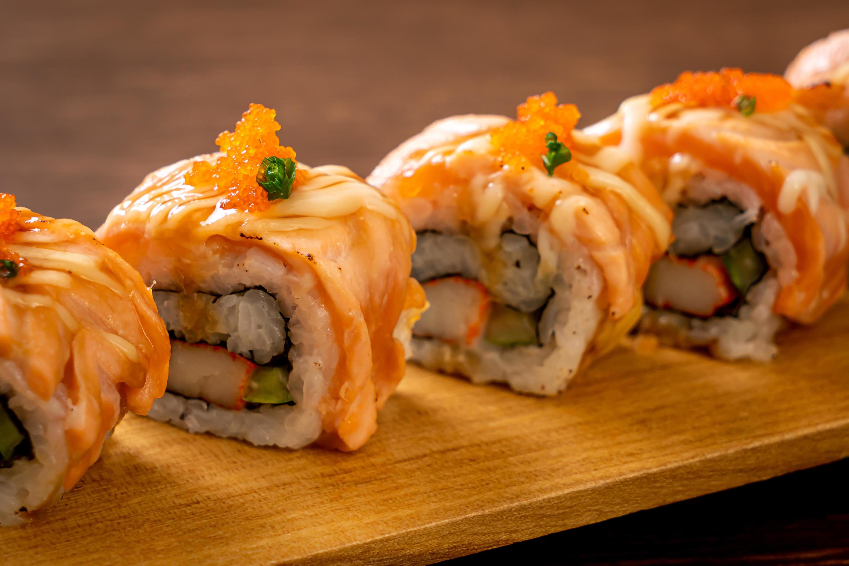 Grilled salmon sushi roll with sauce – Japanese food style Stock Free