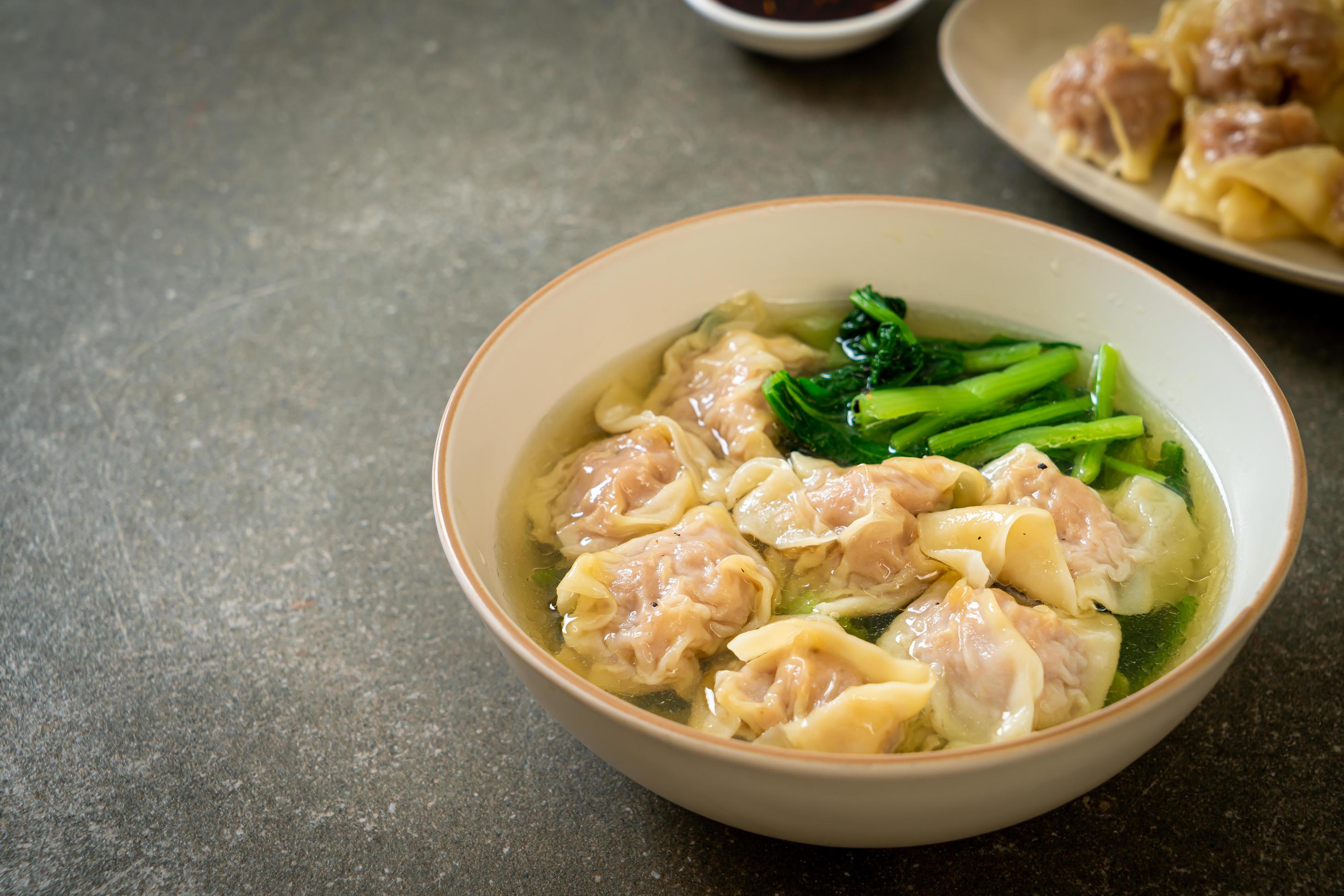 Pork wonton soup or pork dumpling soup with vegetables – Asian food style Stock Free