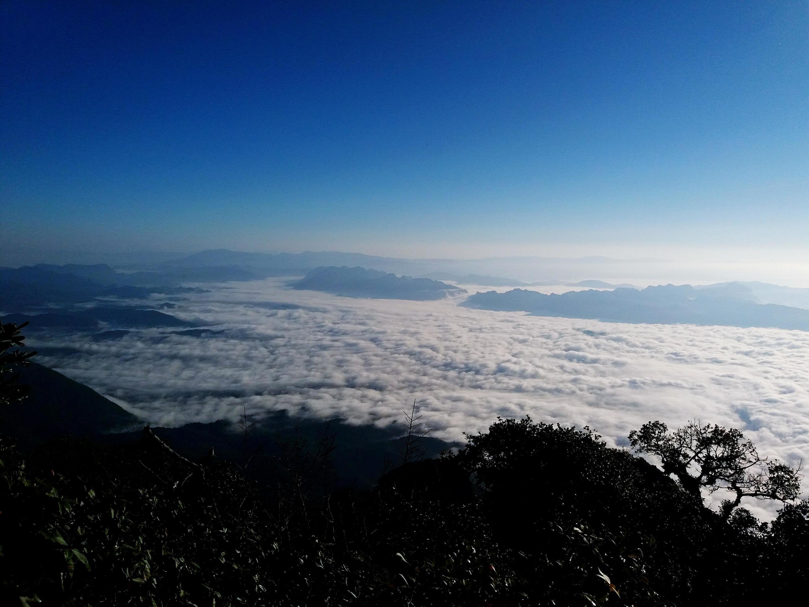 Landscape view of blue sky, white cloud and mist or fog at viewpoint on high mountain in early morning. Beauty in nature and natural wallpaper Stock Free