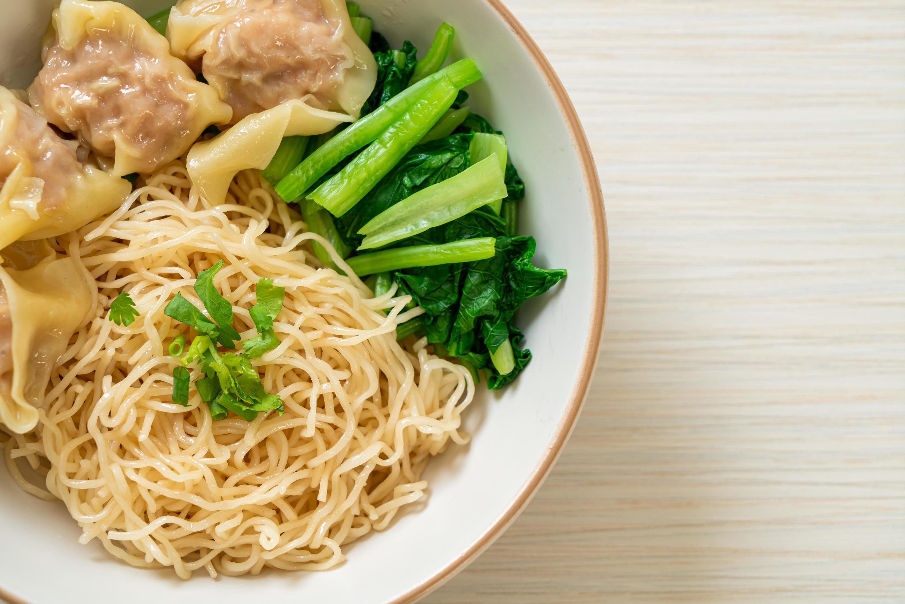 Dried egg noodles with pork wonton or pork dumplings without soup Asian food style Stock Free