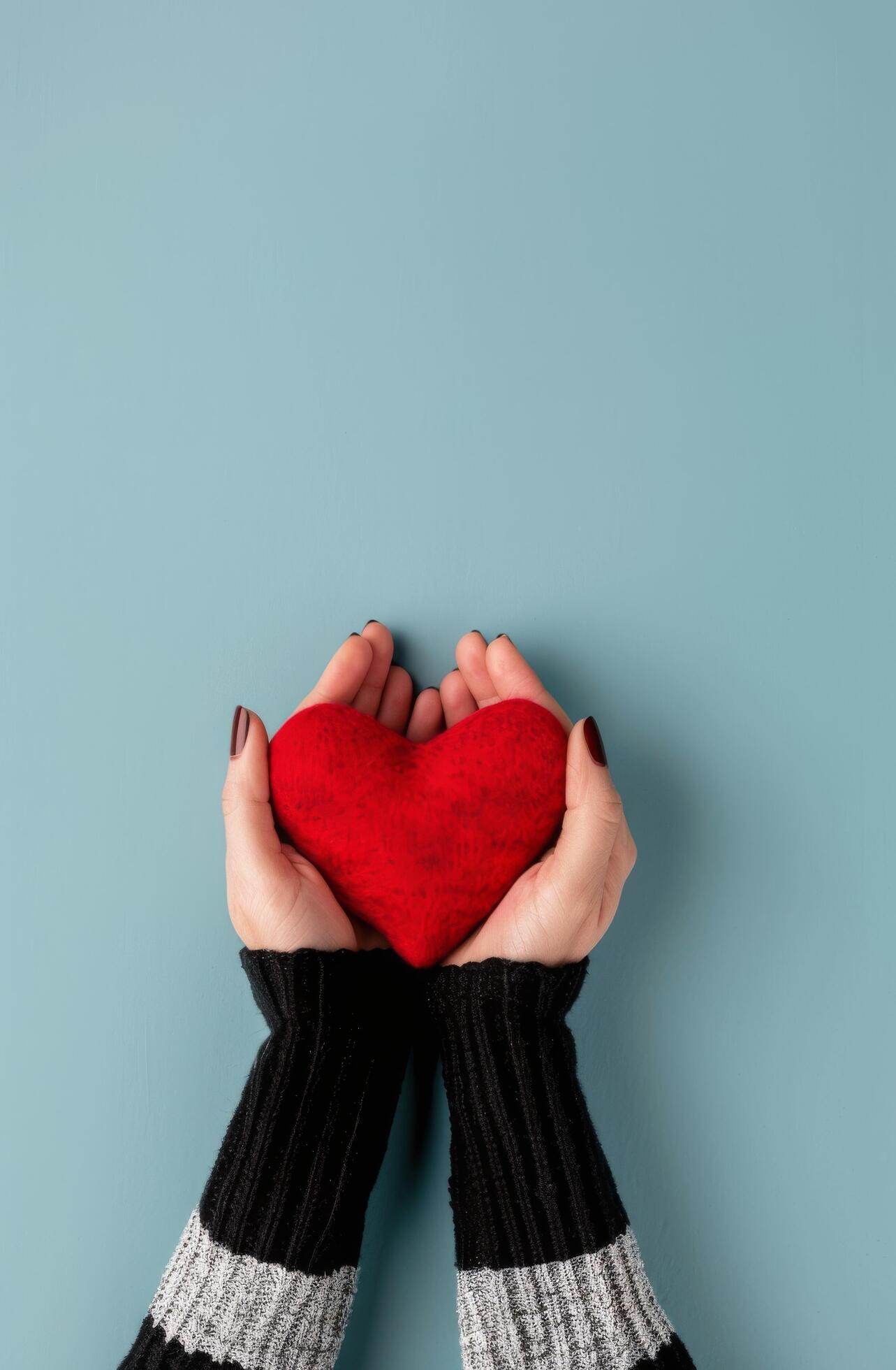 Hands Holding Red Heart on Blue Background Stock Free