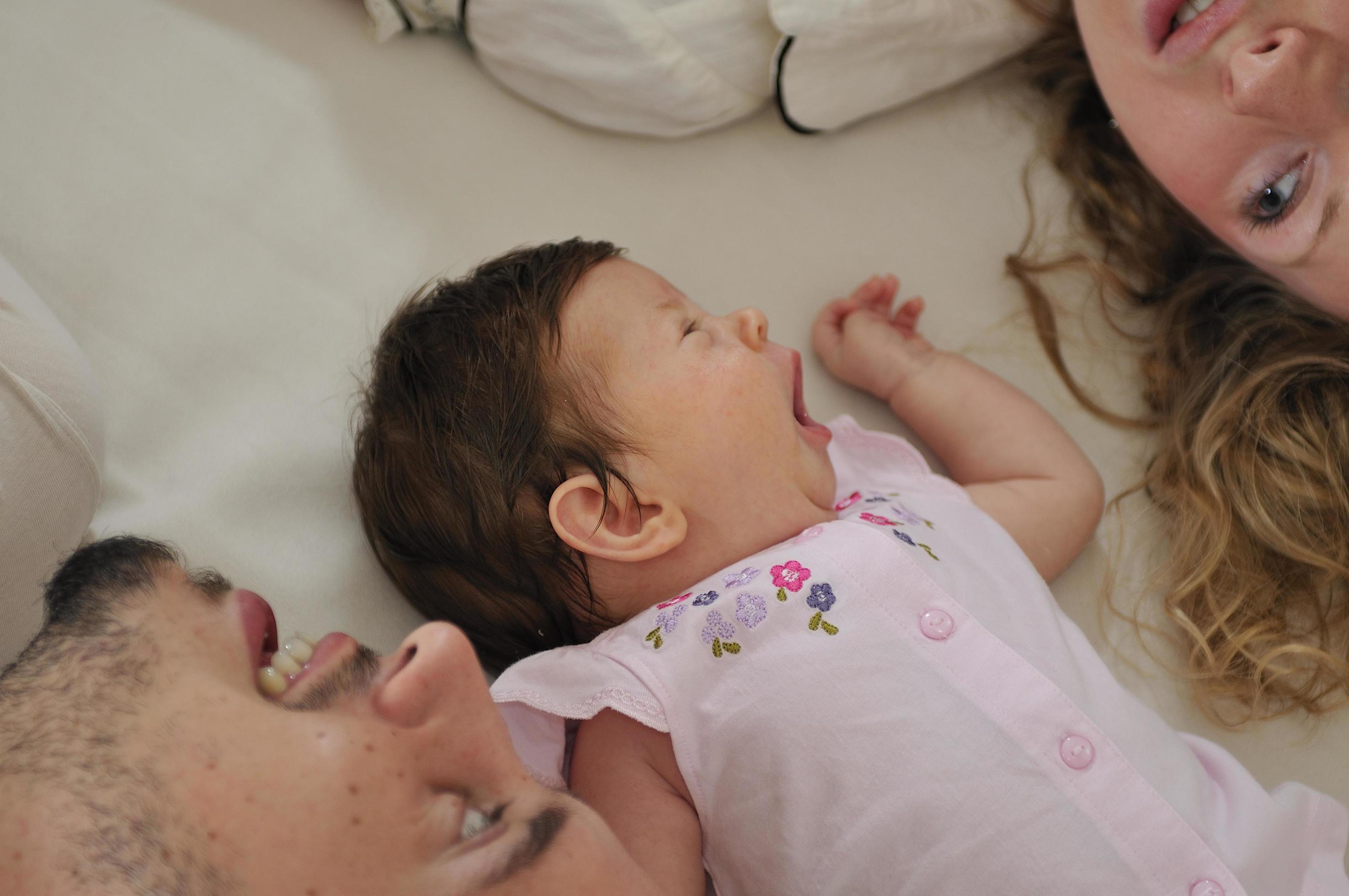 young family playing with cute little baby Stock Free