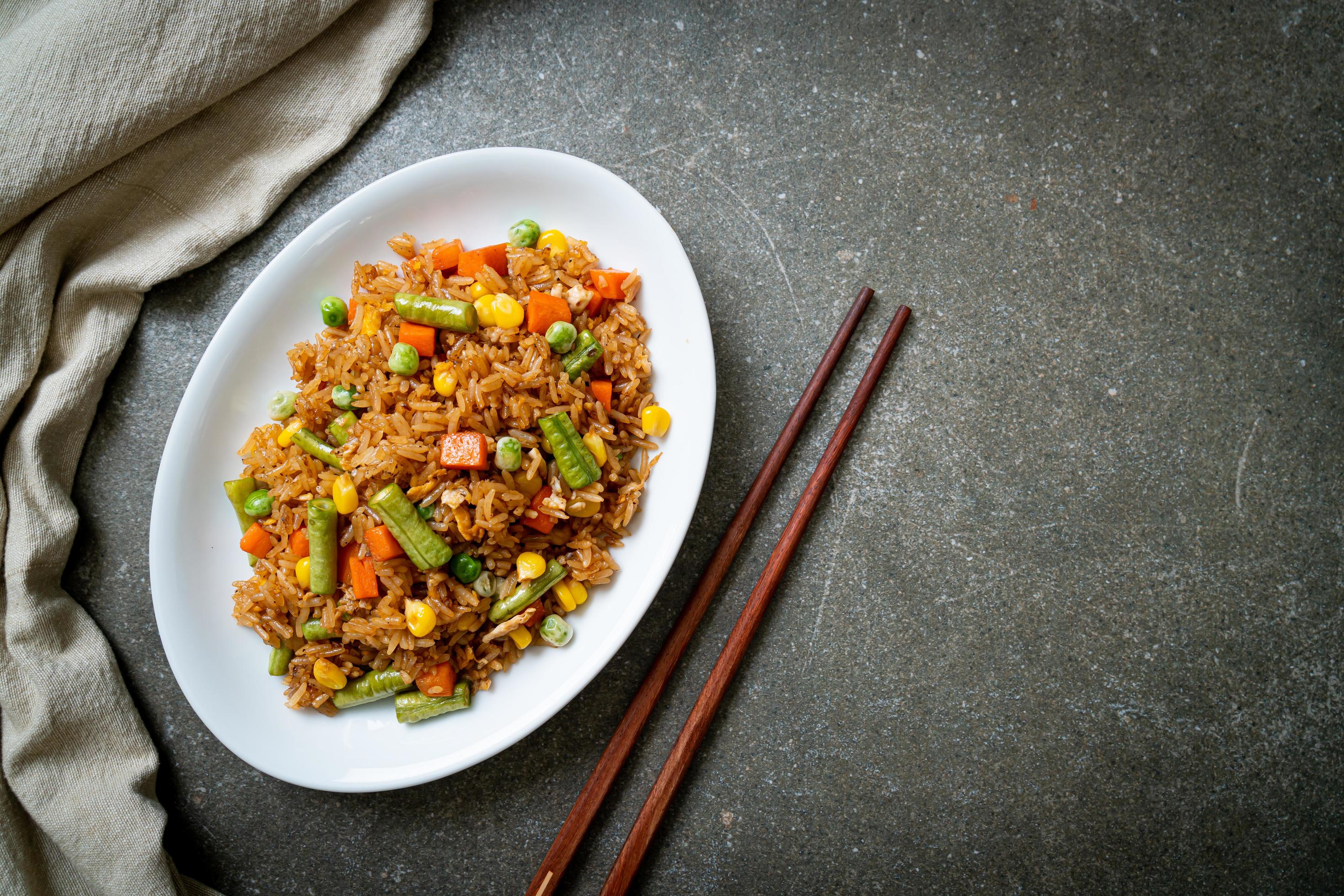 Fried rice with green peas, carrot and corn – vegetarian and healthy food style Stock Free