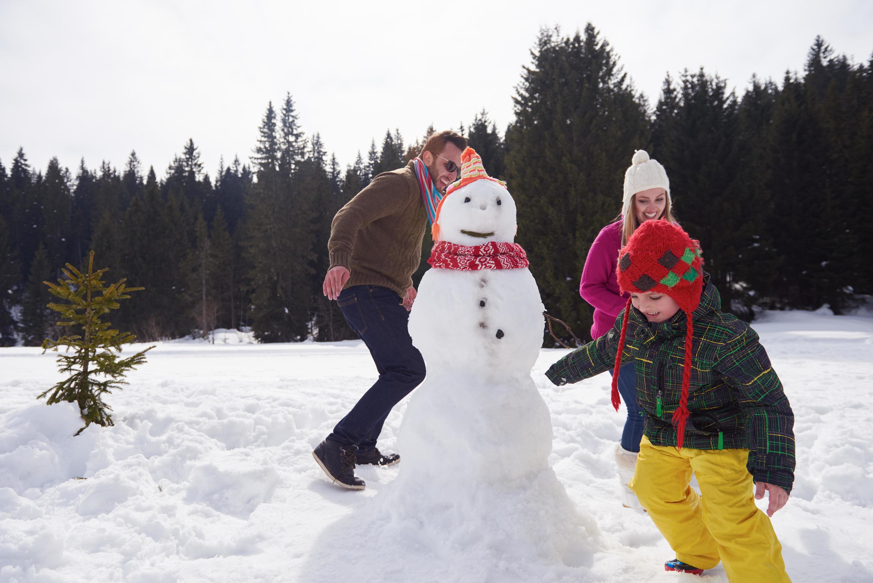 happy family building snowman Stock Free