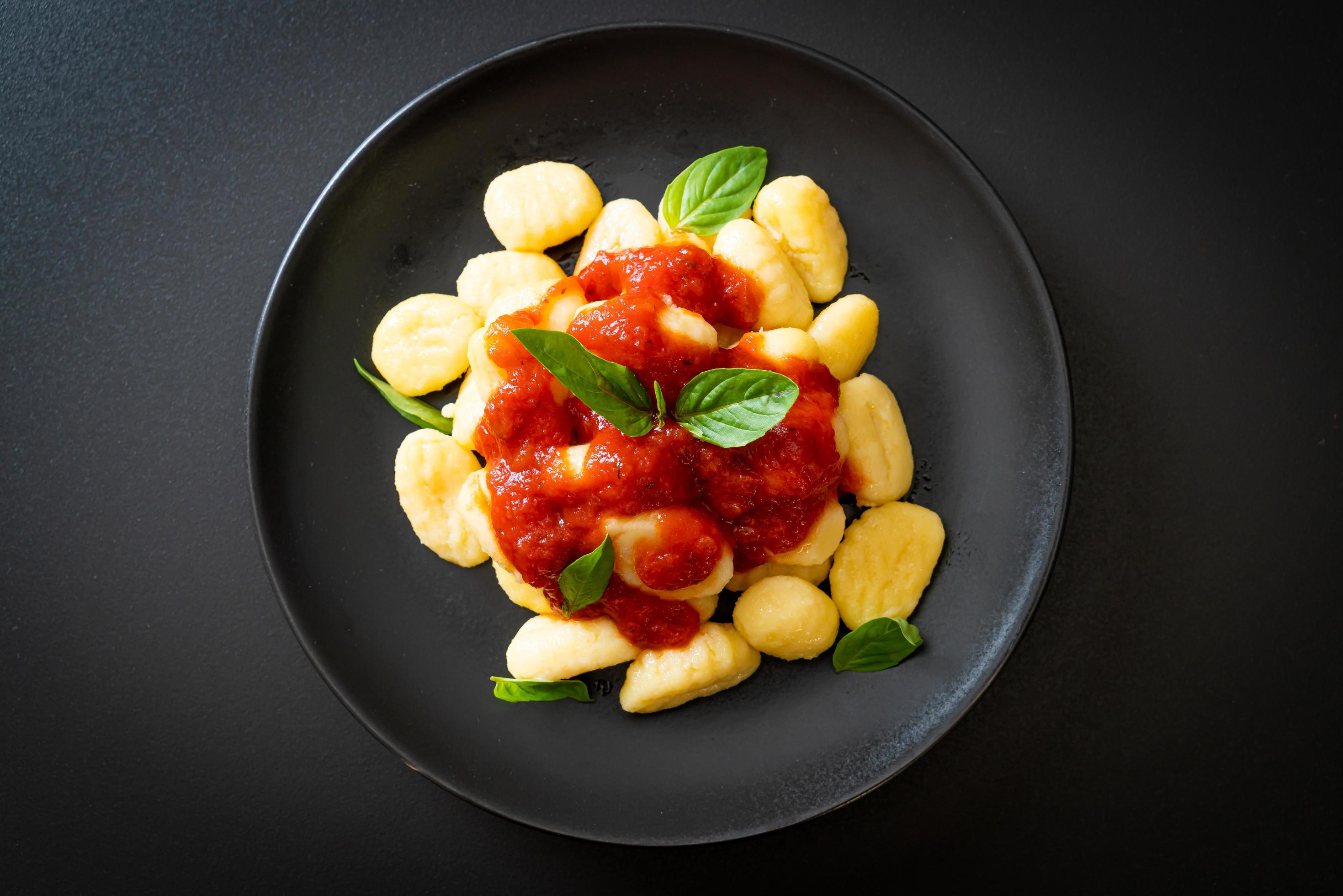 Gnocchi in tomato sauce with cheese – Italian food style Stock Free