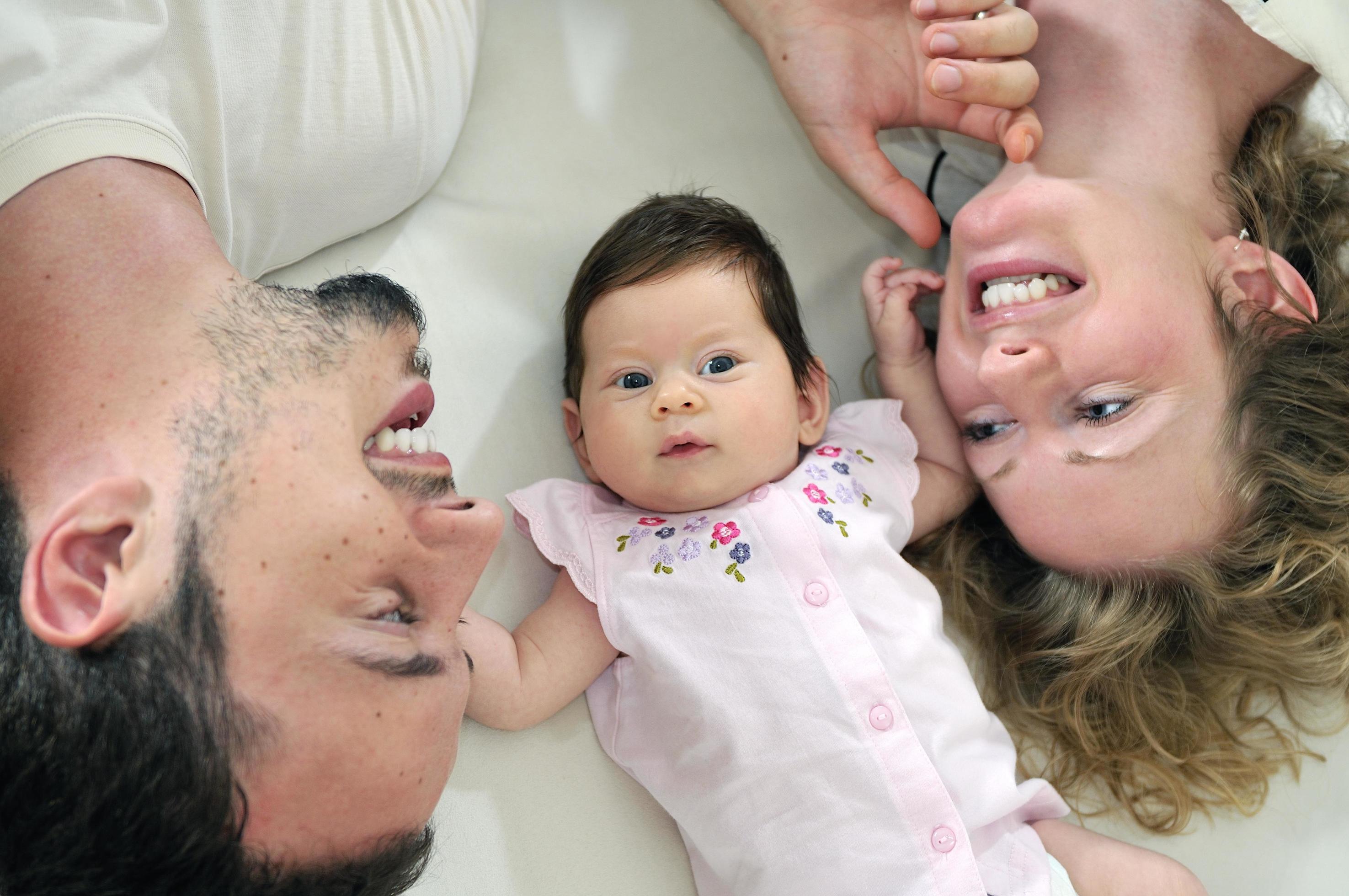 indoor portrait with happy young family and cute little babby Stock Free