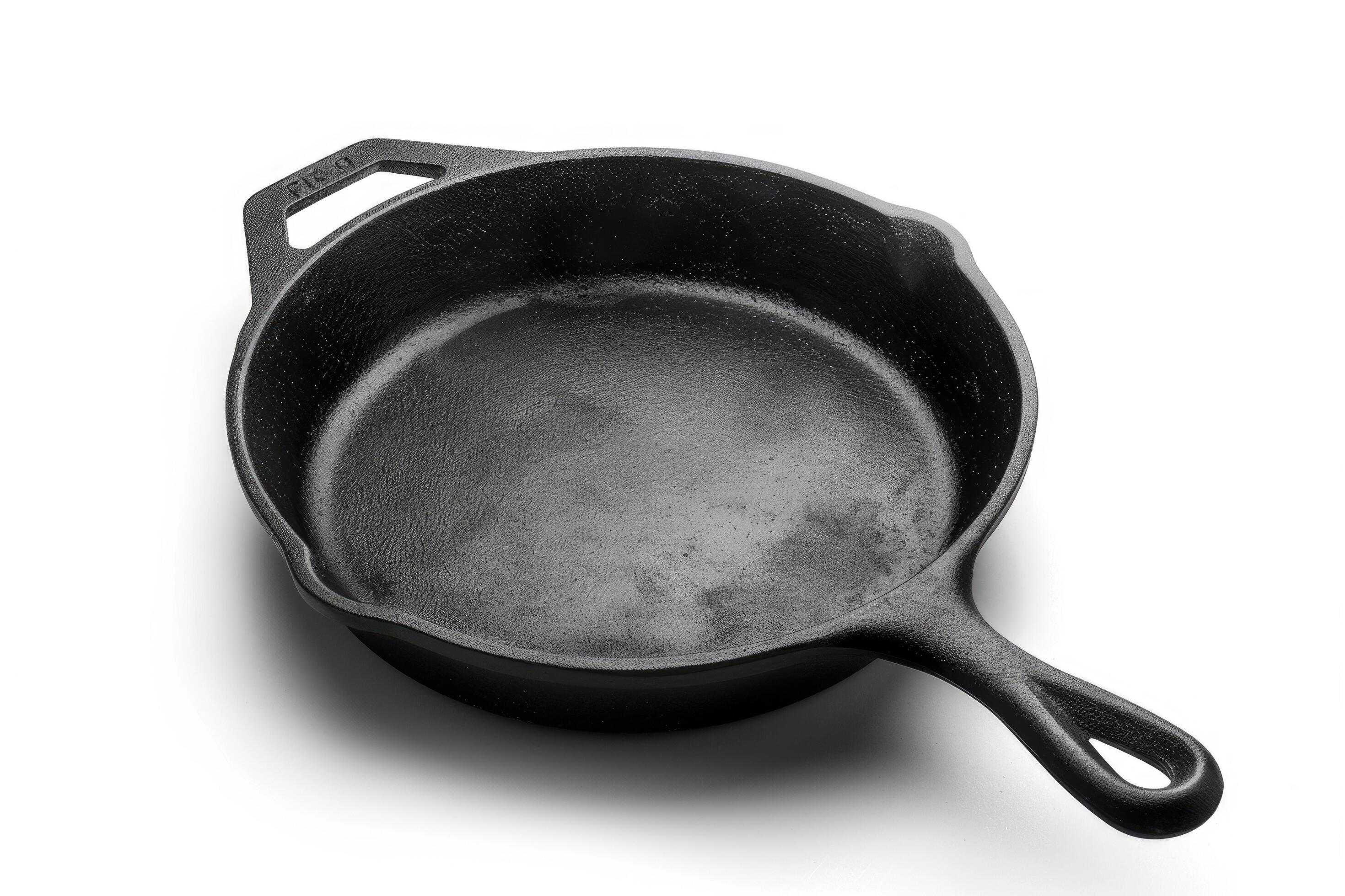 Black cast iron skillet on a white background. Stock Free