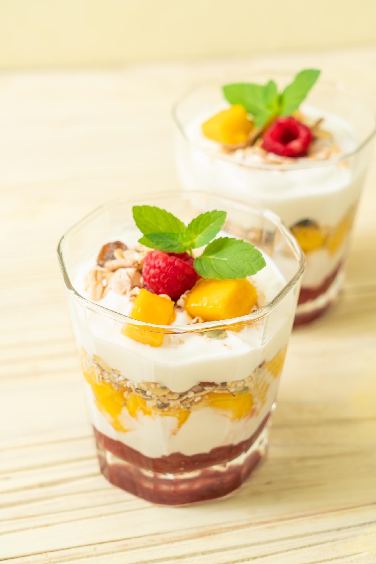 Homemade fresh mango and fresh raspberry with yogurt and granola – healthy food style Stock Free