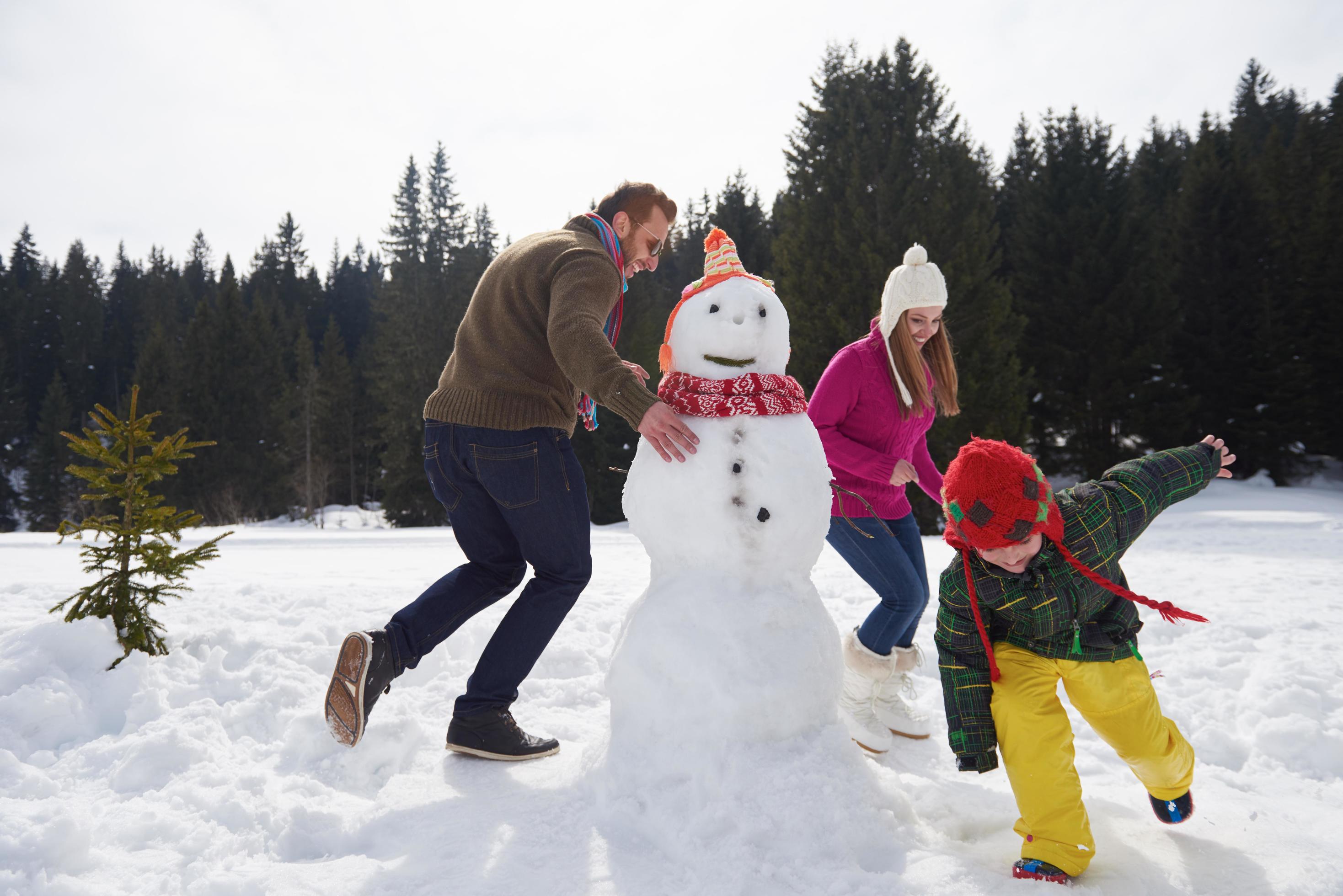 happy family building snowman Stock Free