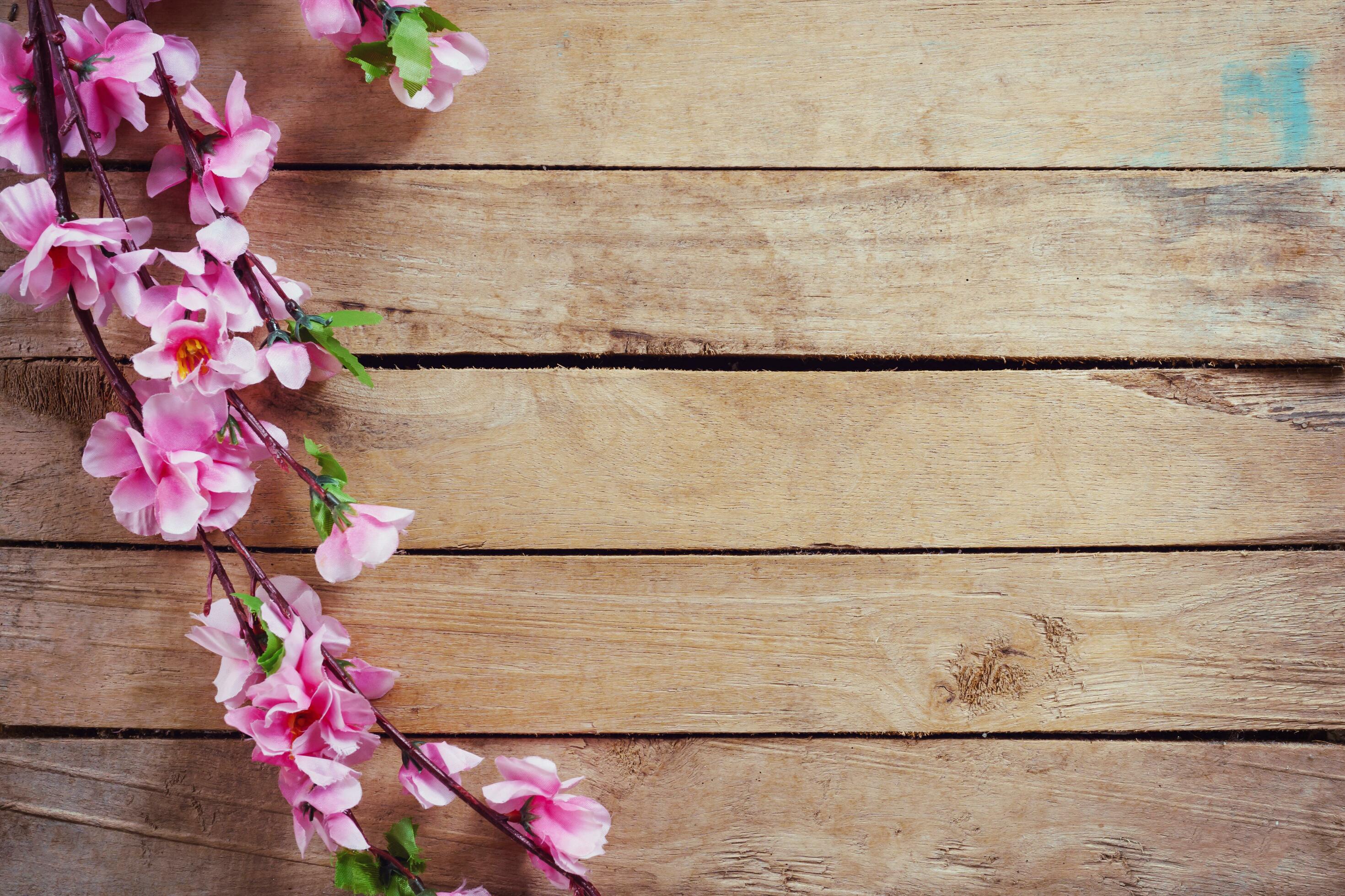 Cherry blossom and Artificial flowers on vintage wooden background with copy space. Stock Free