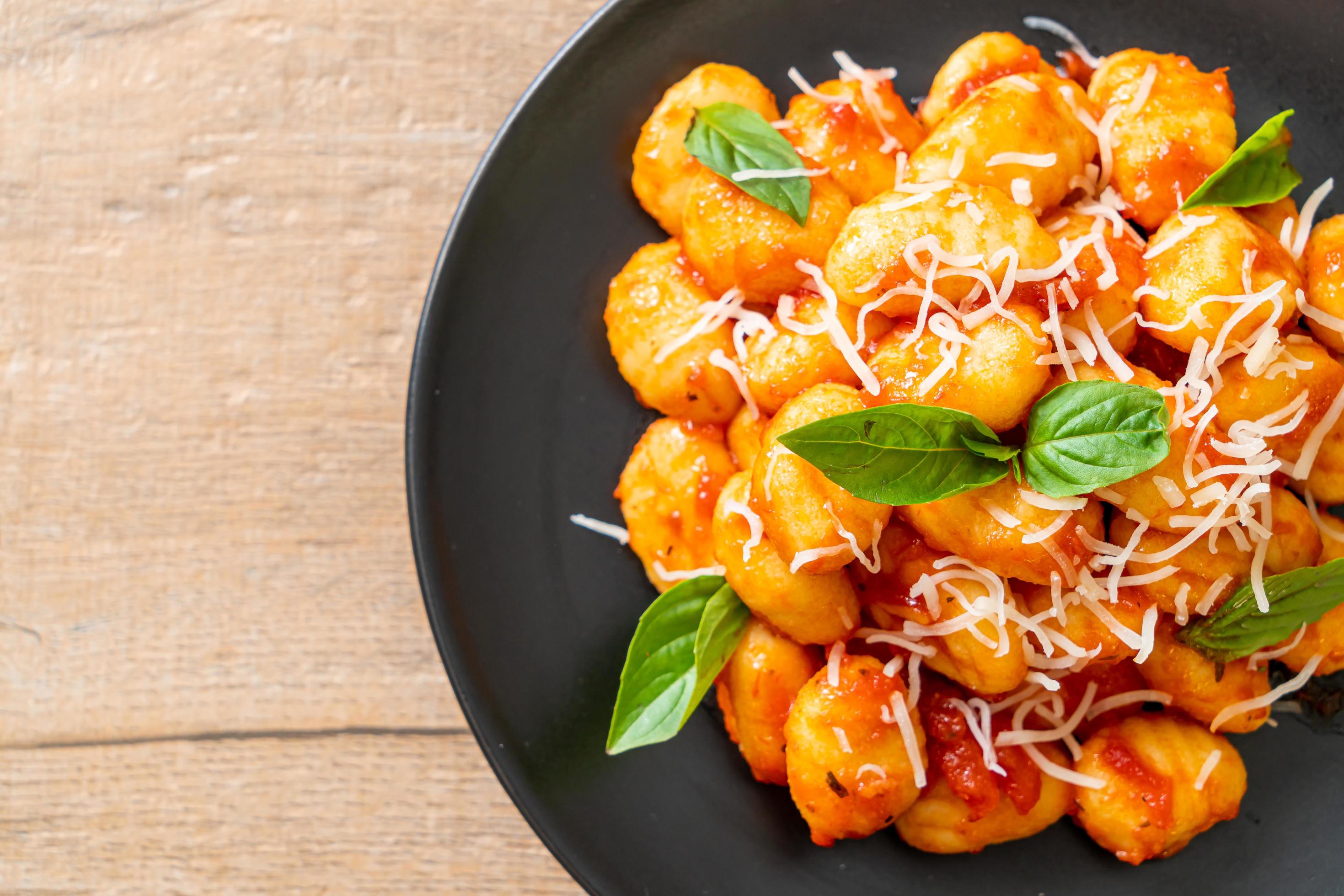 Gnocchi in tomato sauce with cheese – Italian food style Stock Free